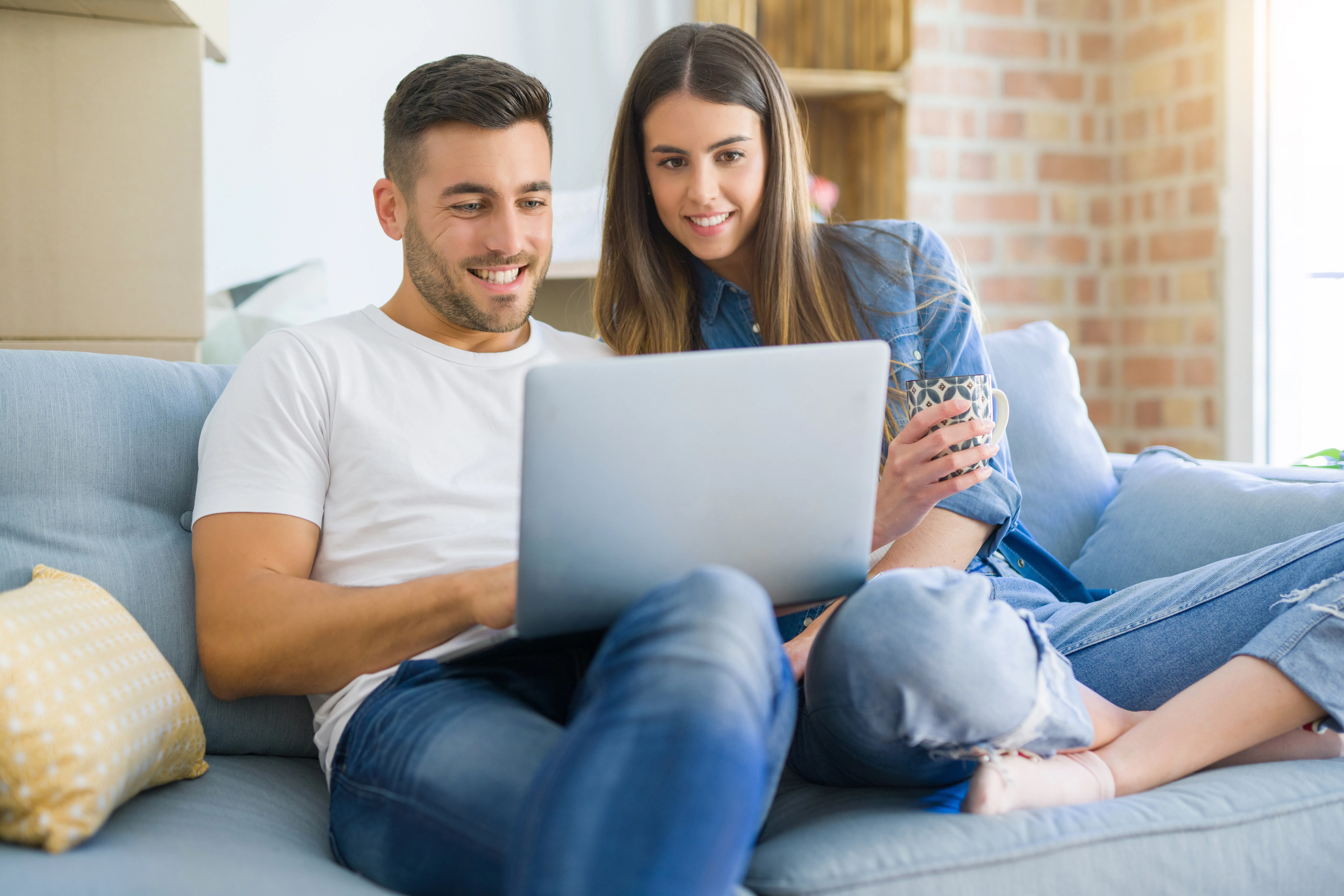 Young couple looking at laptop screen.