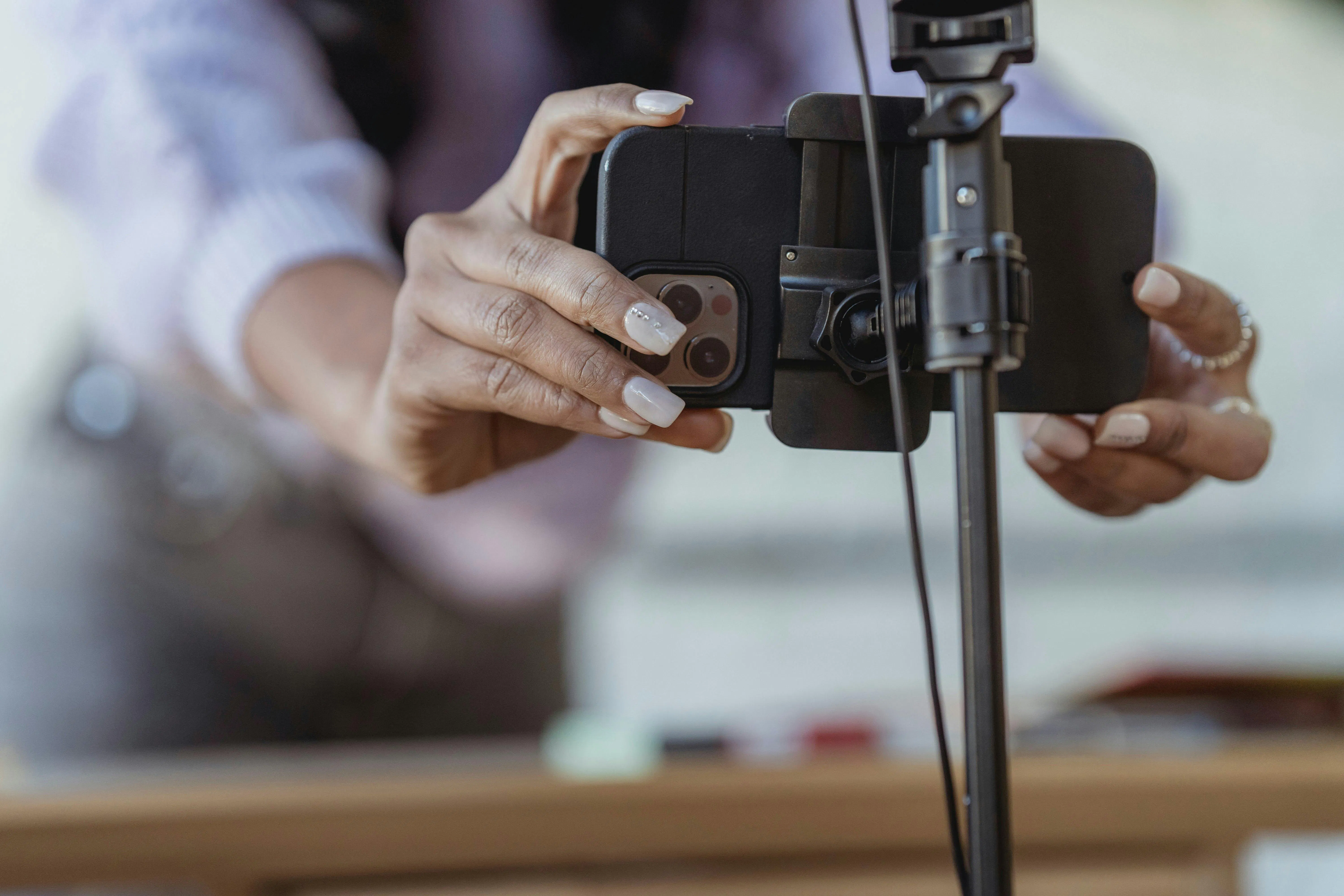 Woman recording video on iPhone tripod