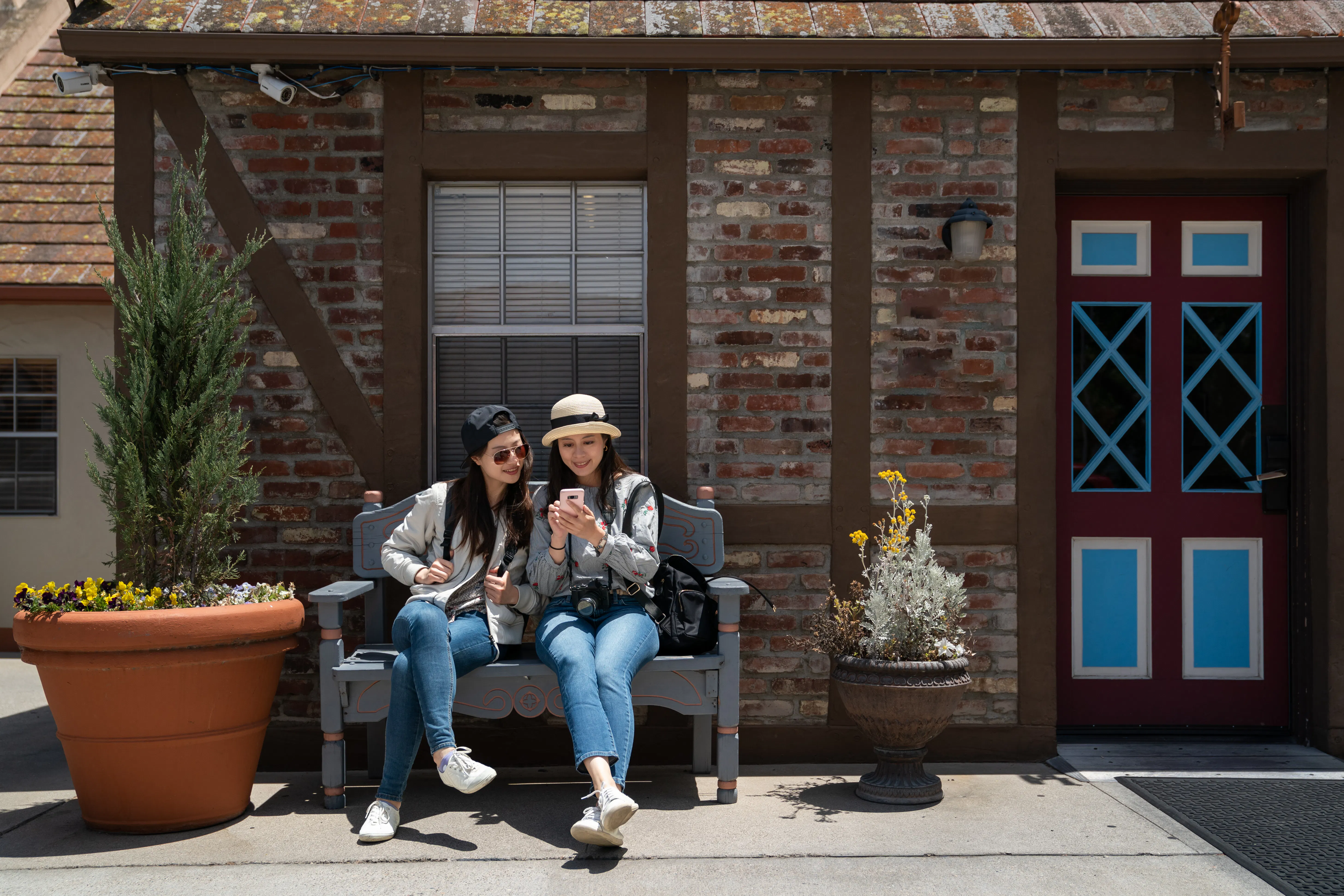 friends on a bench outside of a building