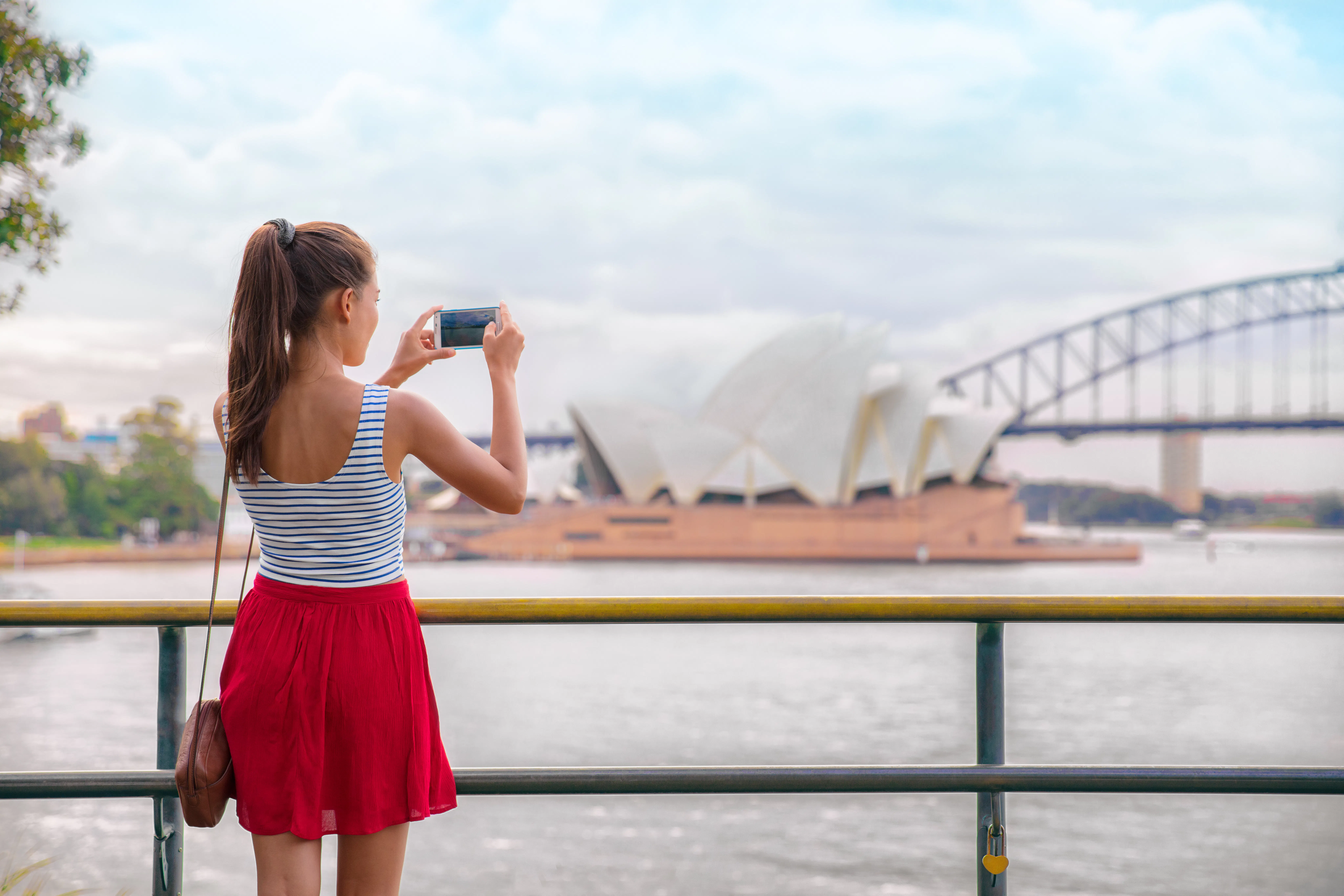 Tourist taking photo of Sydney Opera House