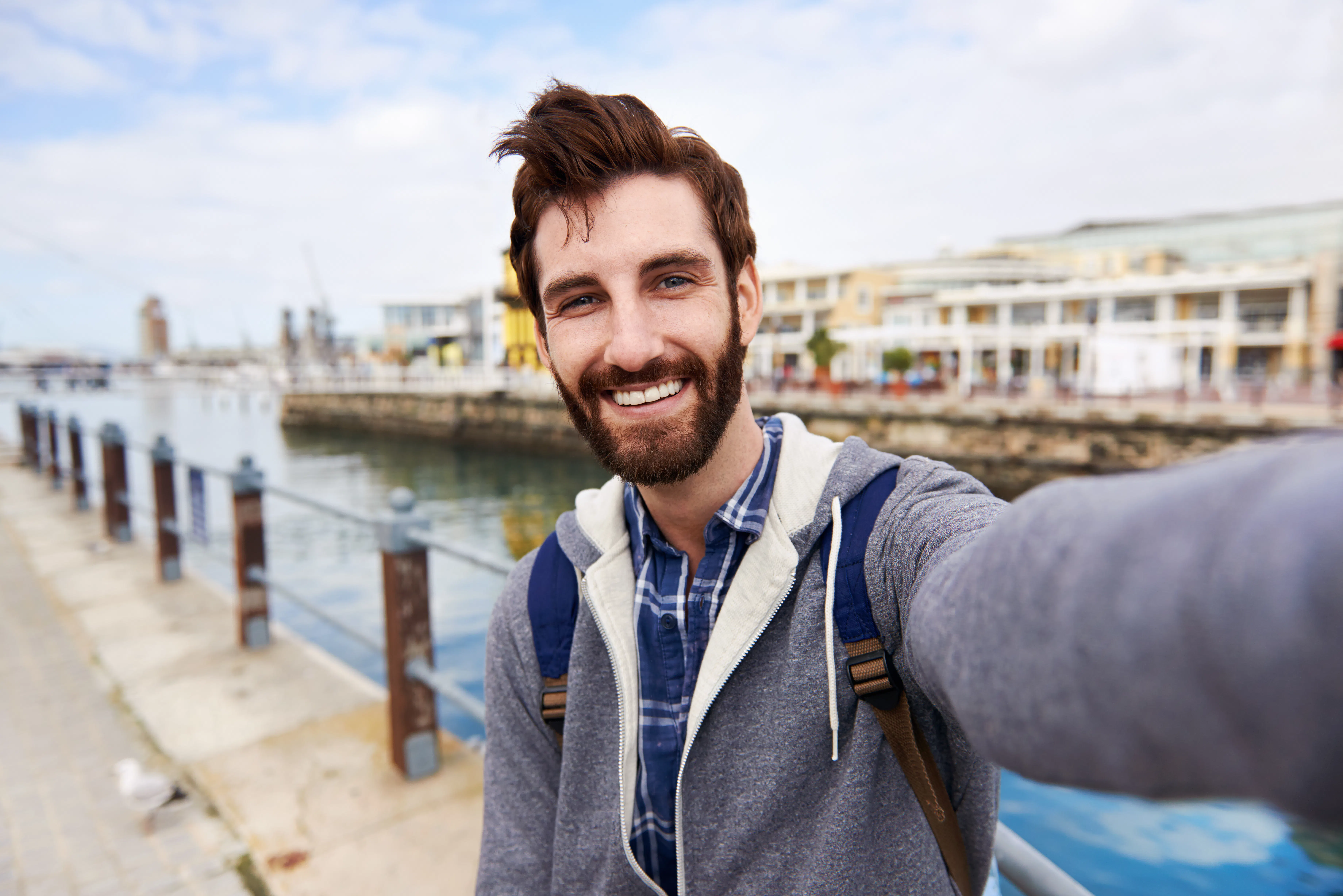 Man taking selfie by water