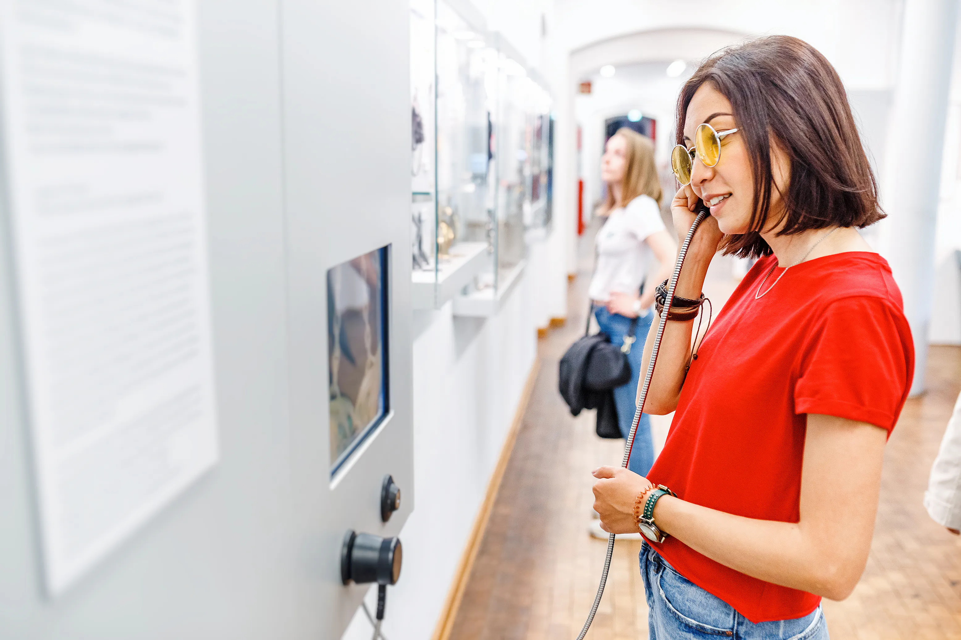 Woman listening to audio at museum