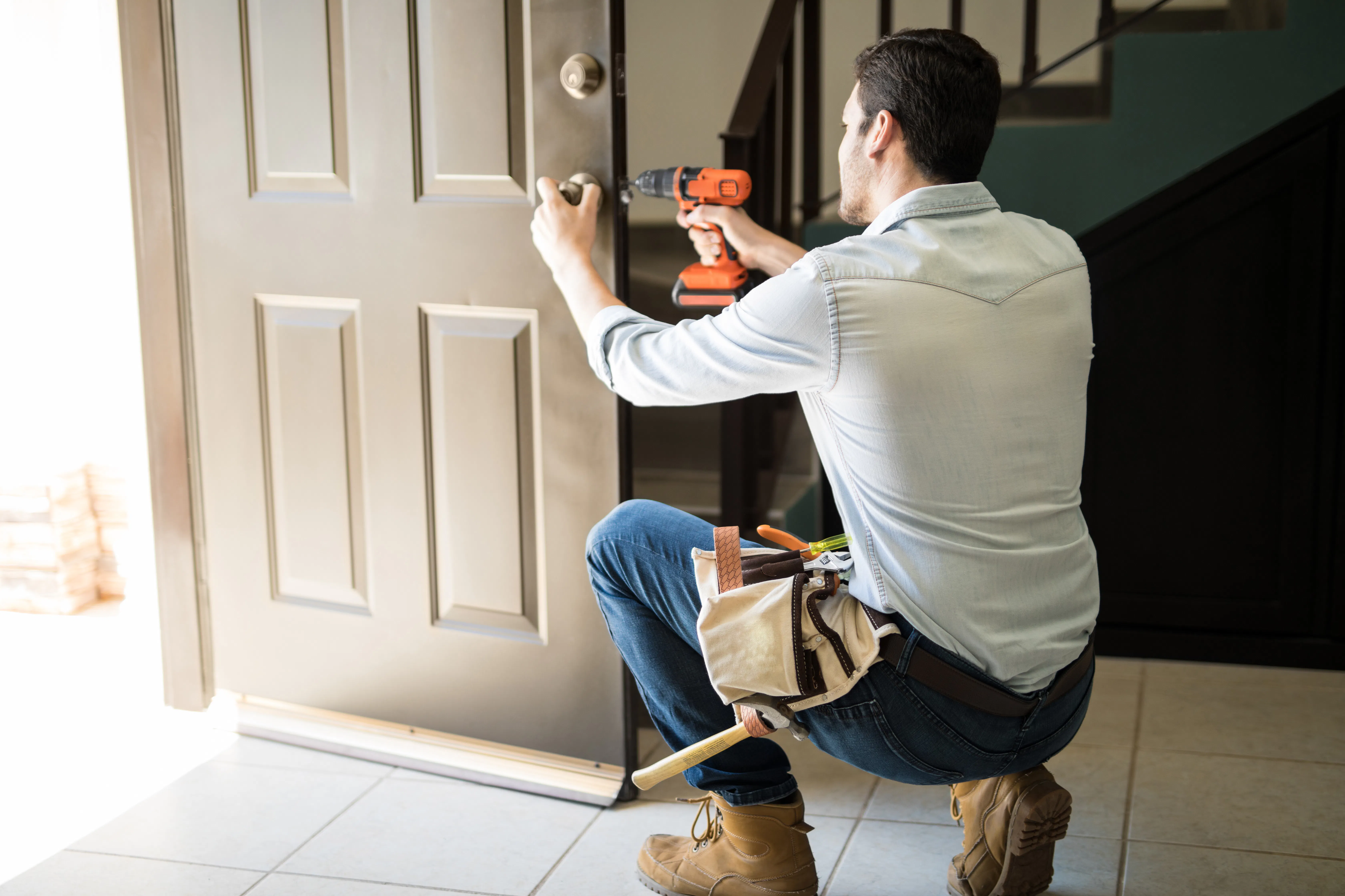Handyman fixing residential door lock