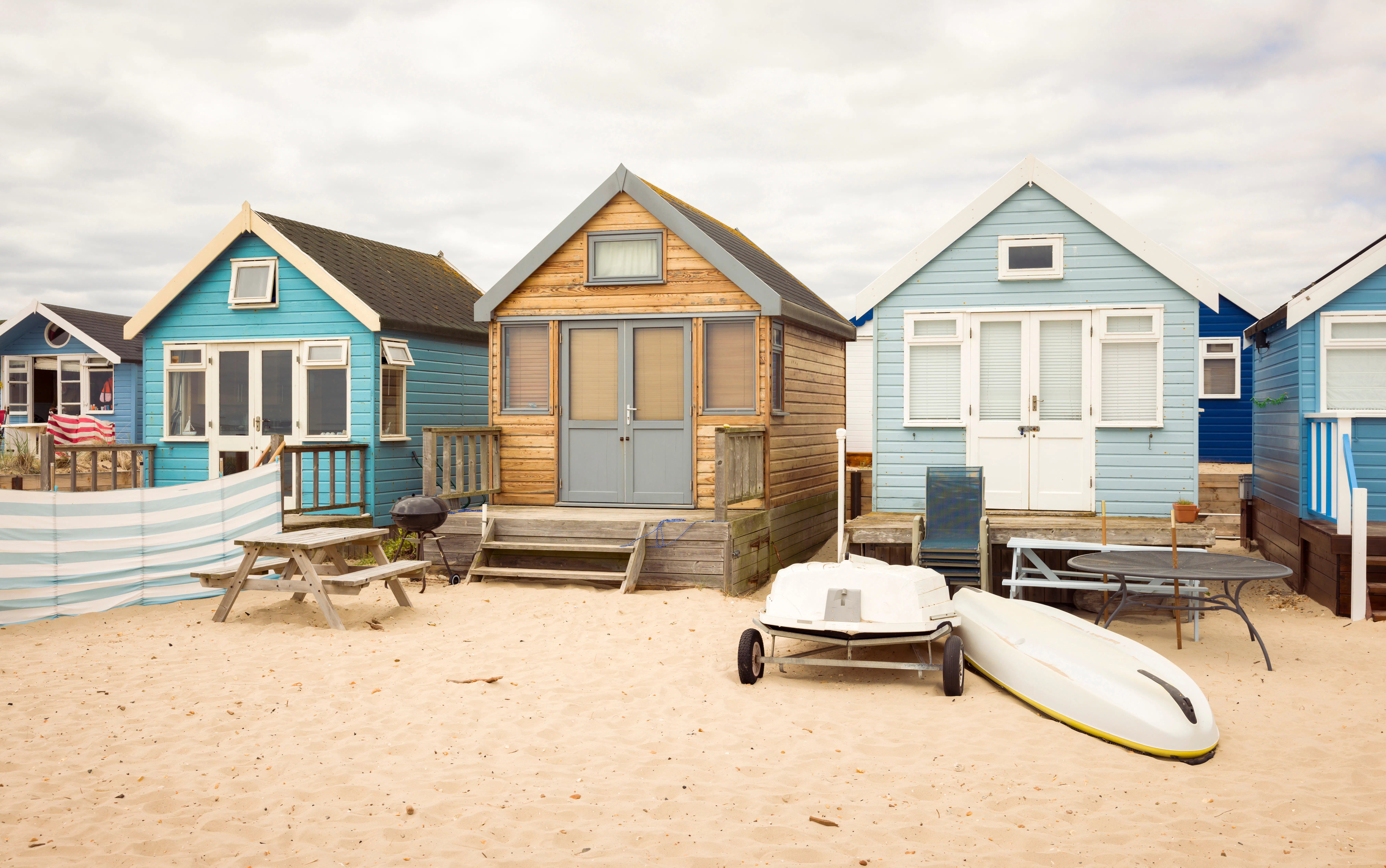 Beach houses on sandy beach, Hengistbury Head, Dorset, UK
