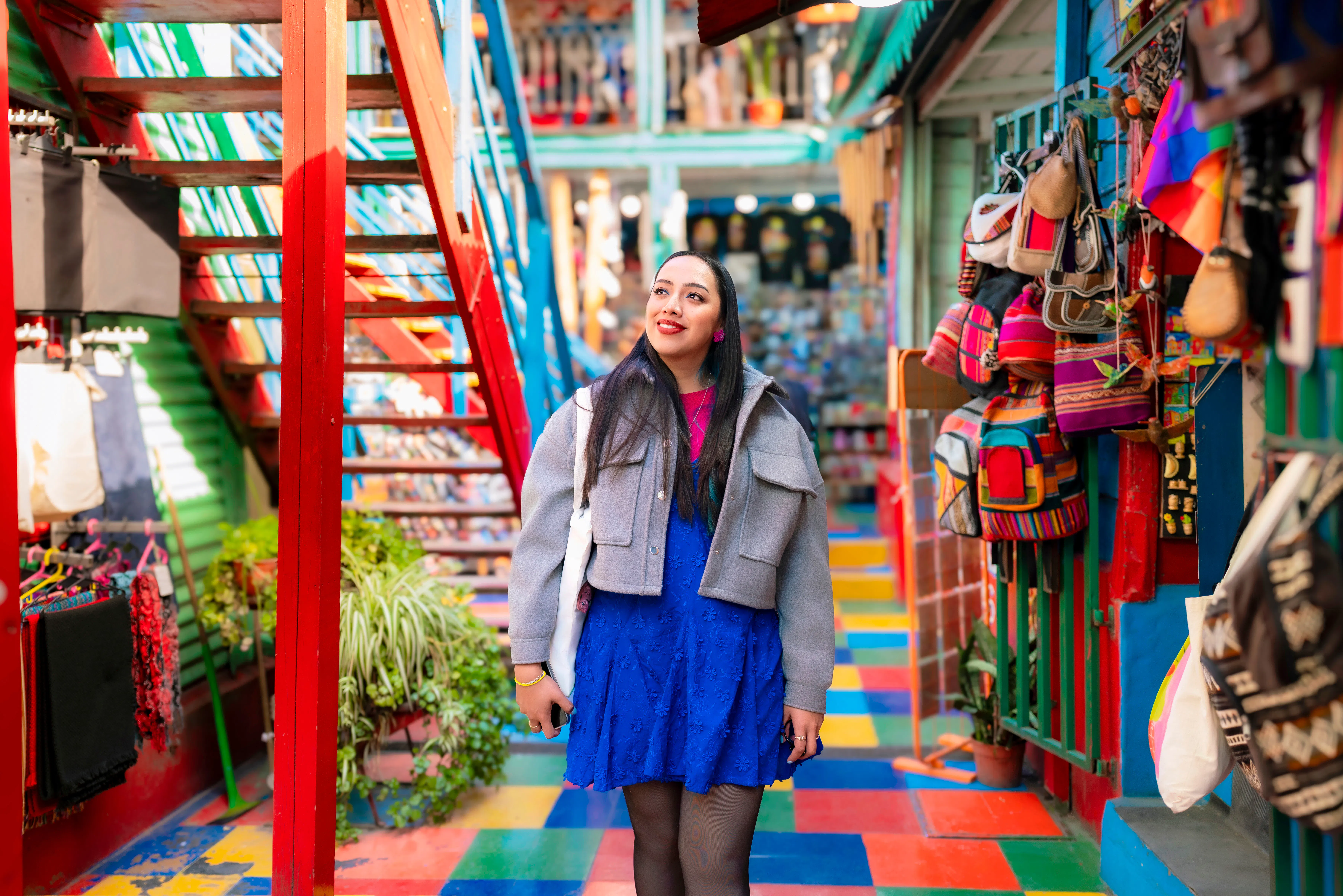 Woman walking through colorful commerce corridor