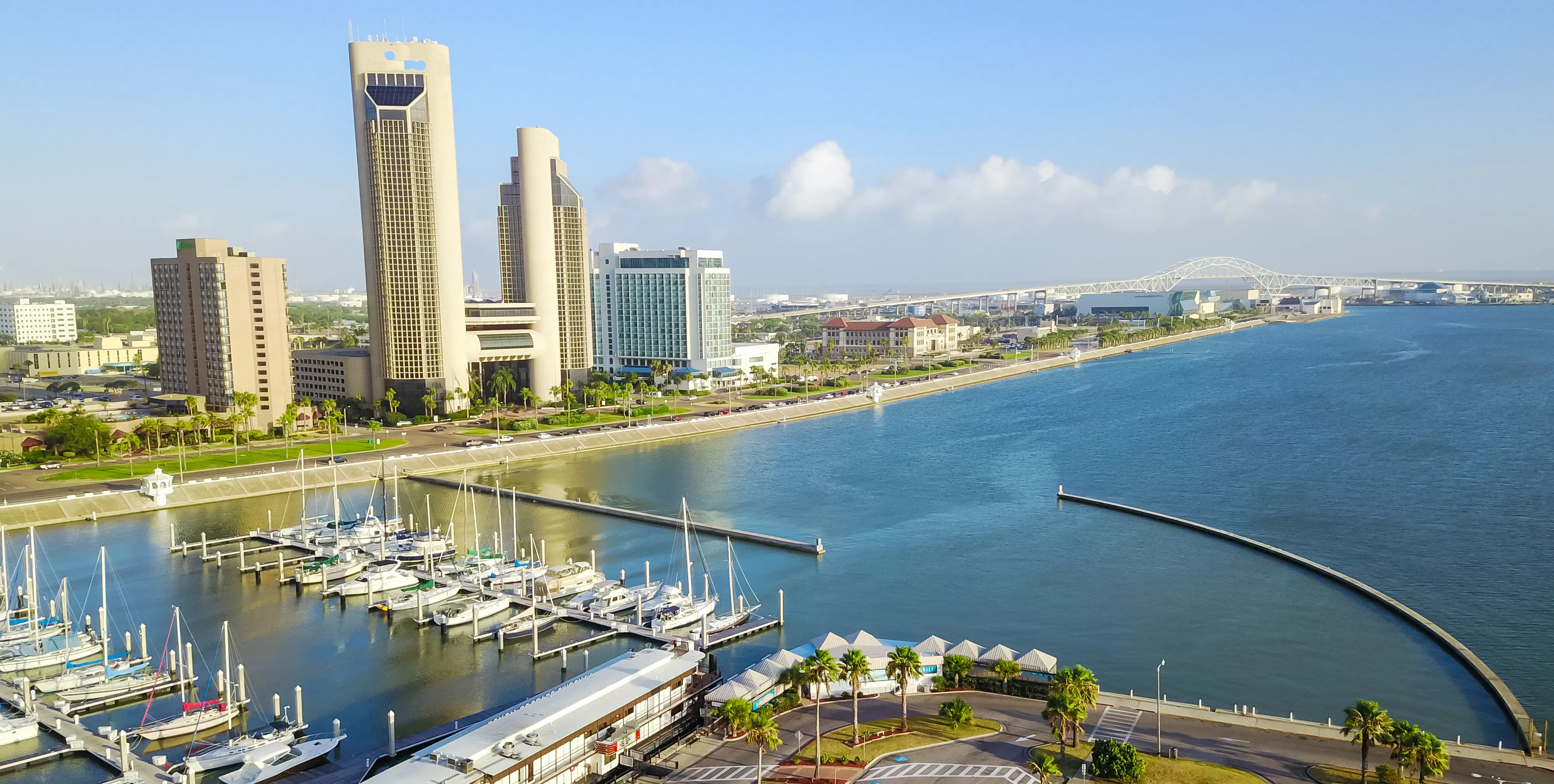 Panorama aerial view Bayfront area of Corpus Christi with skylines and marina piers row of boat, sailboat and yacht at sunrise