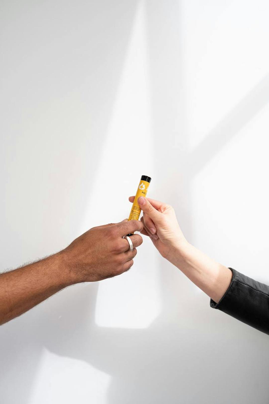 Two people passing a joint