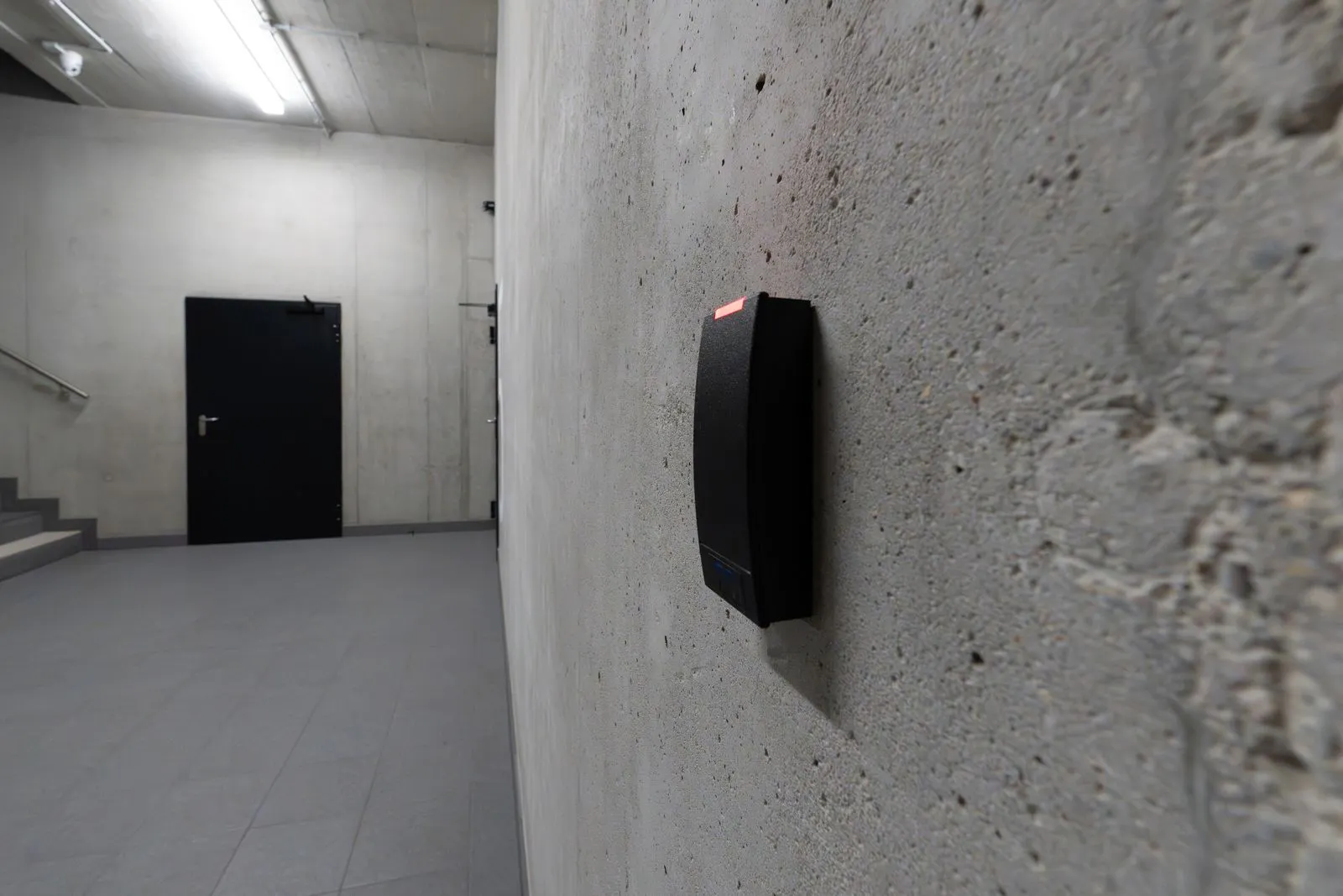 Electronic access control terminal mounted on a wall, representing zero trust security controls