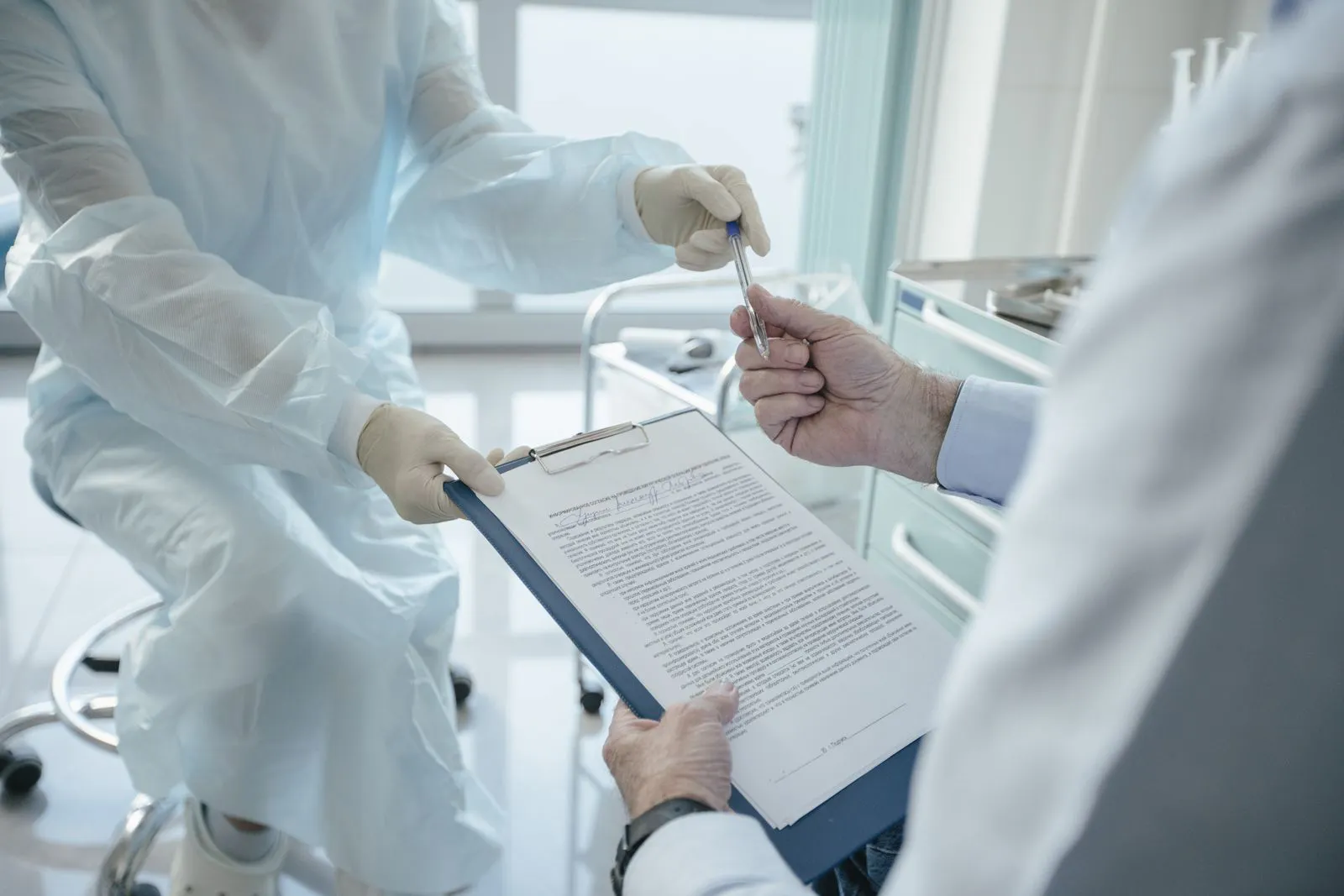 Medical professional filling out a patient intake form
