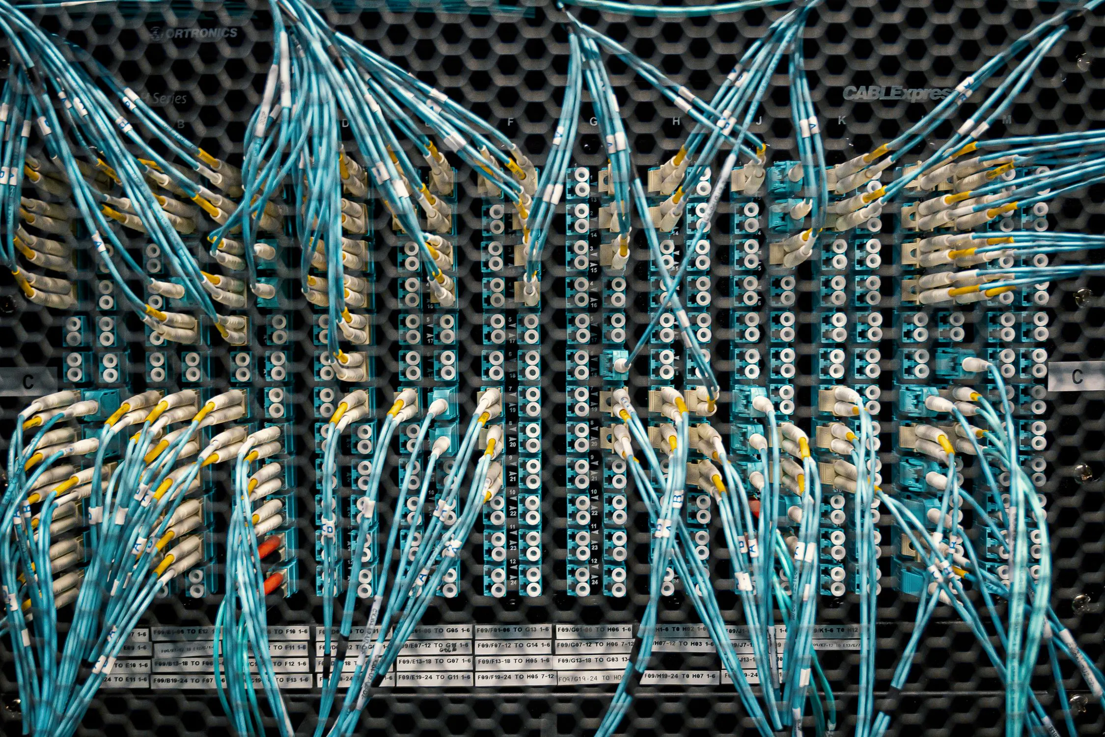 Fiber optic cables connected in a data center switch, representing system integration infrastructure