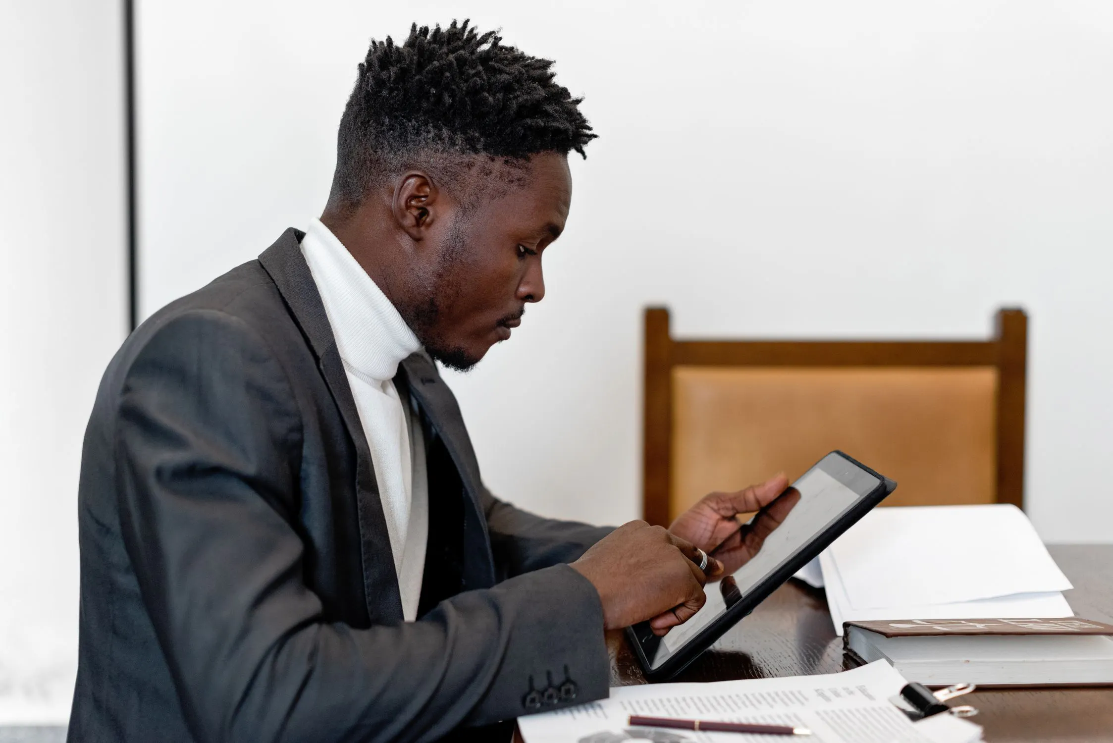 Government office worker reviewing documents on tablet, representing digital workflow modernization