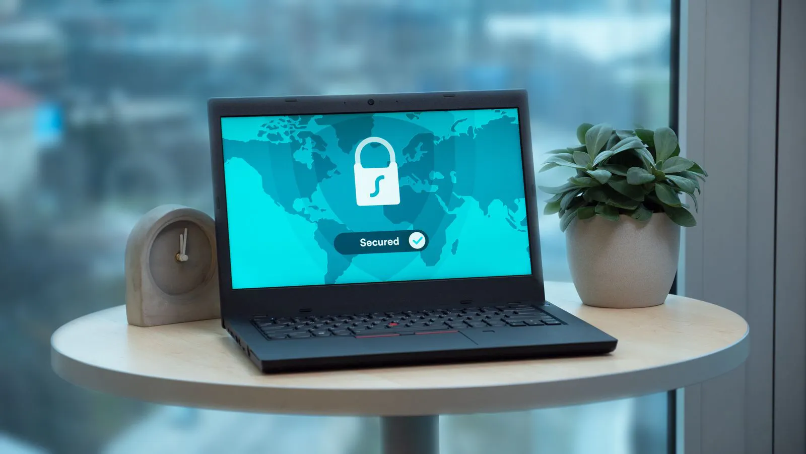 Laptop displaying a security lock icon on a table, representing government data access security