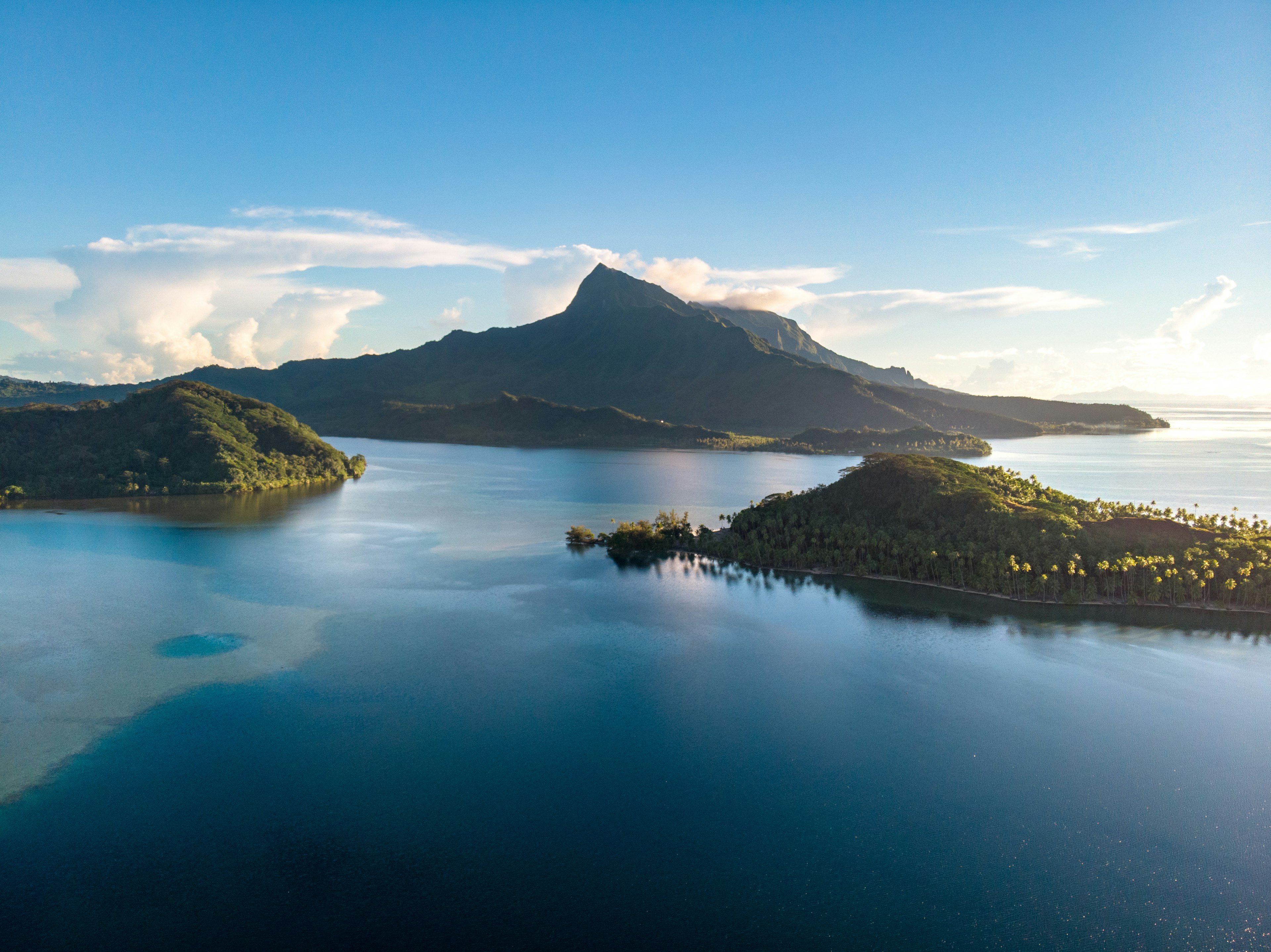 Raiatea island view from the sky with lagoon and sun goes down