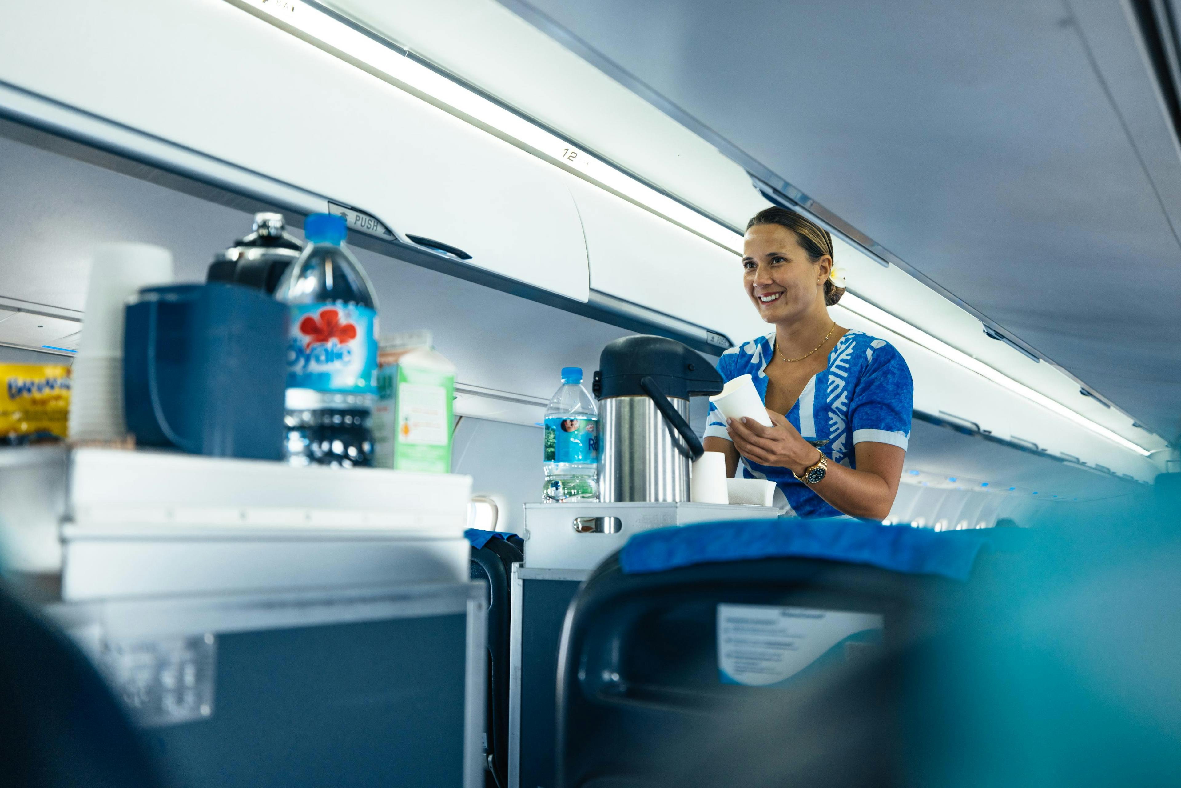 Air Moana crew serving a drink