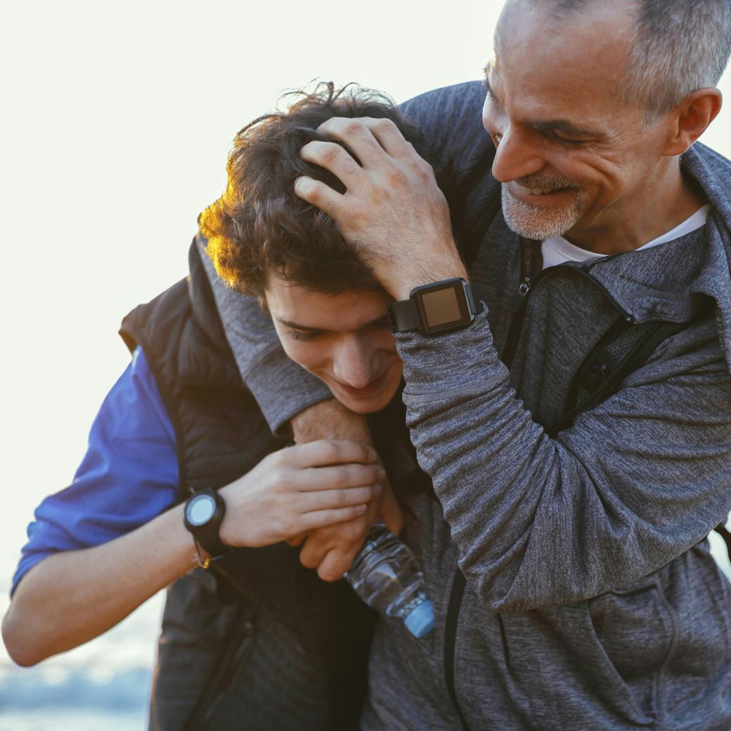 Father mussing son's hair