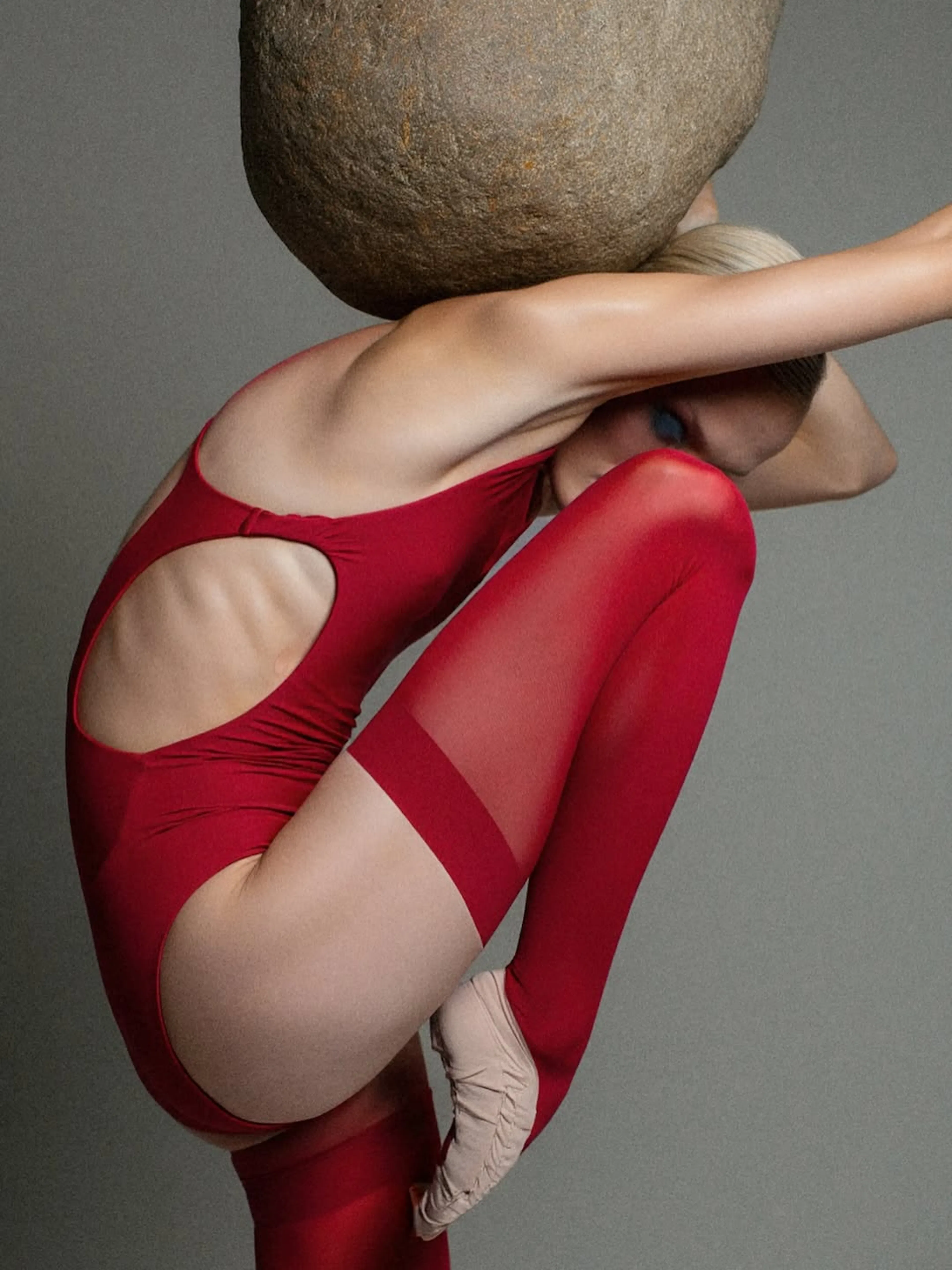 girl wearing red outfit and stone on her back