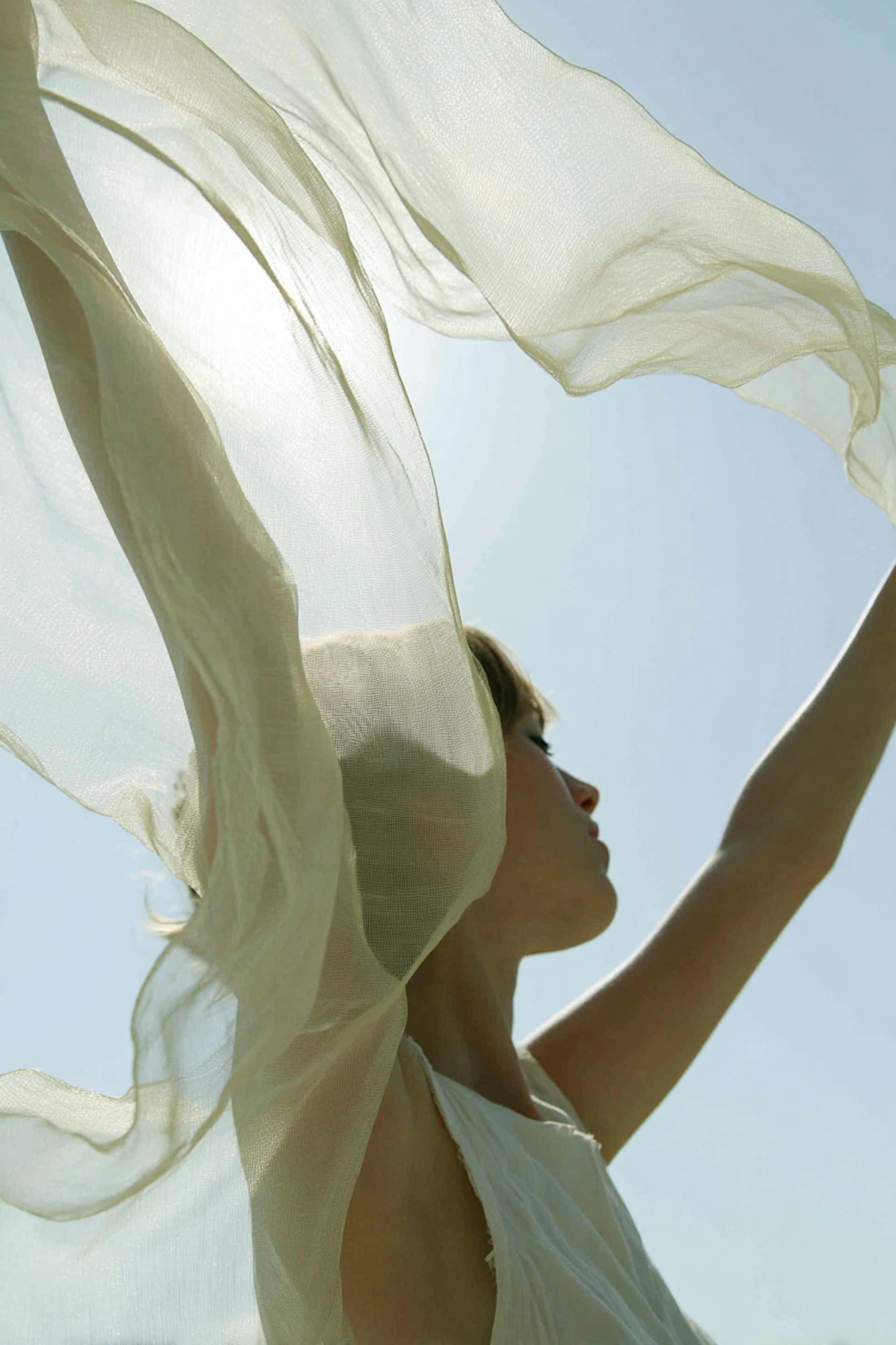 girl throwing green veil in the sky