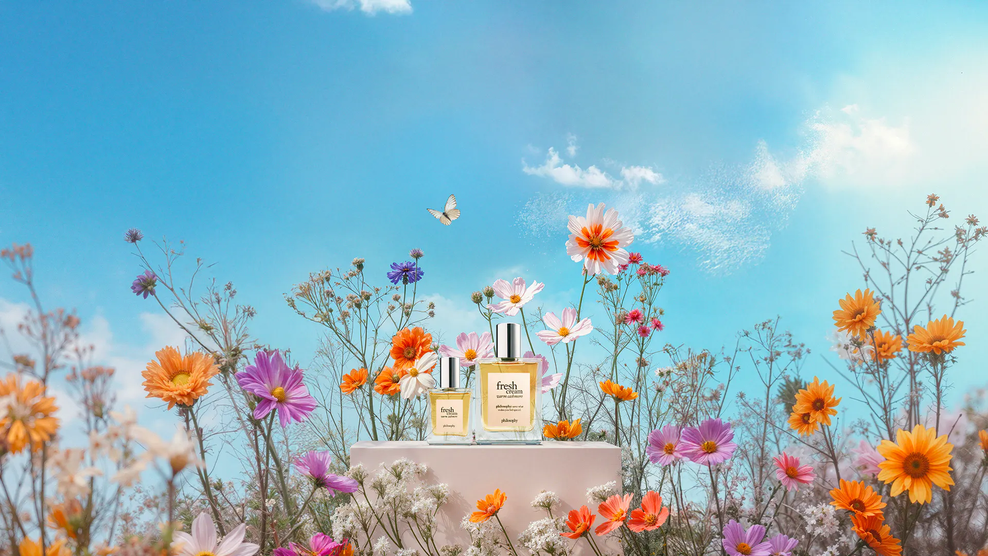 packshots of perfume with pink and orange flowers