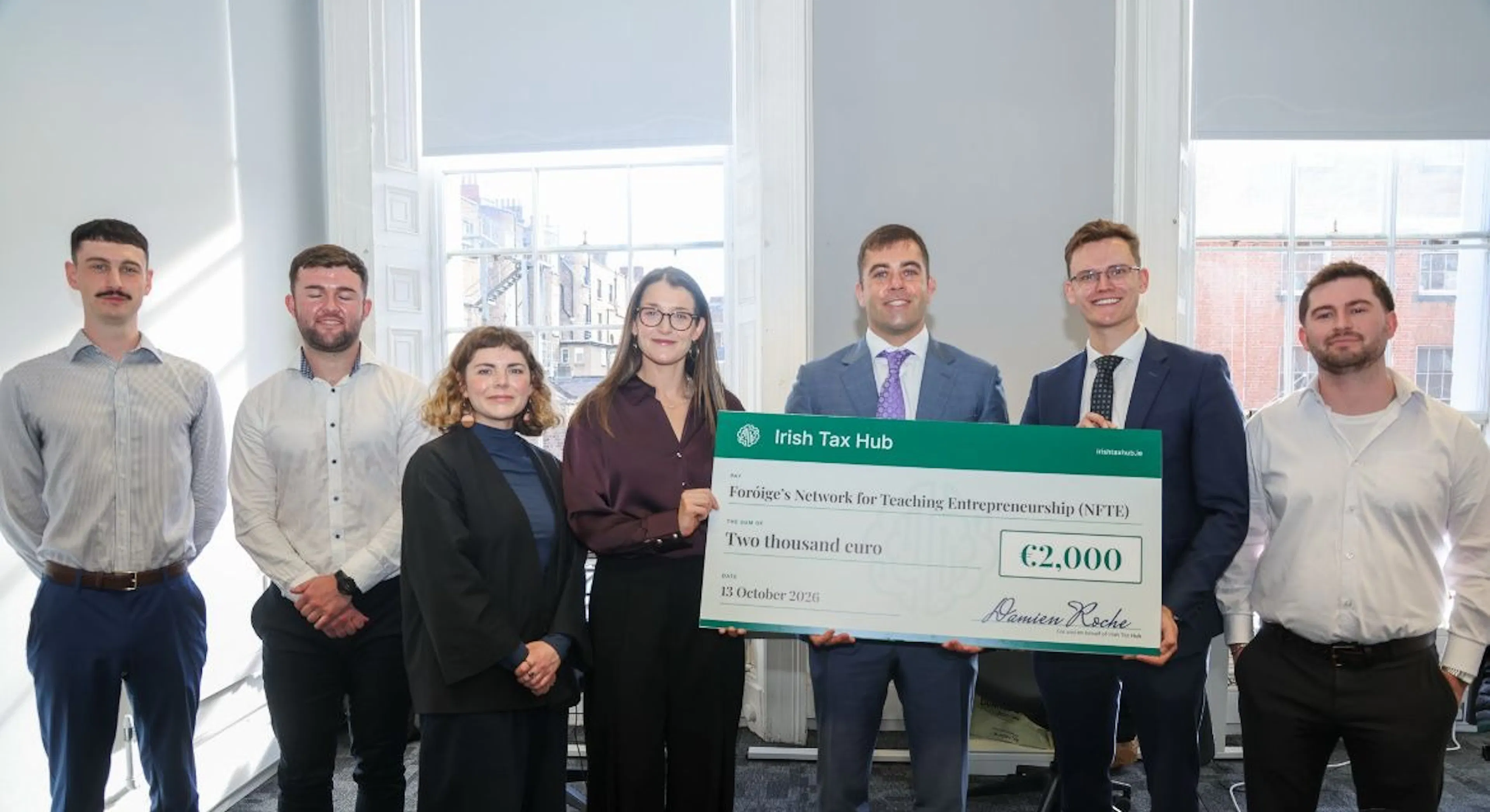 Irish Tax Hub presenting a €2,000 cheque to the Foróige NFTE team at the office opening
