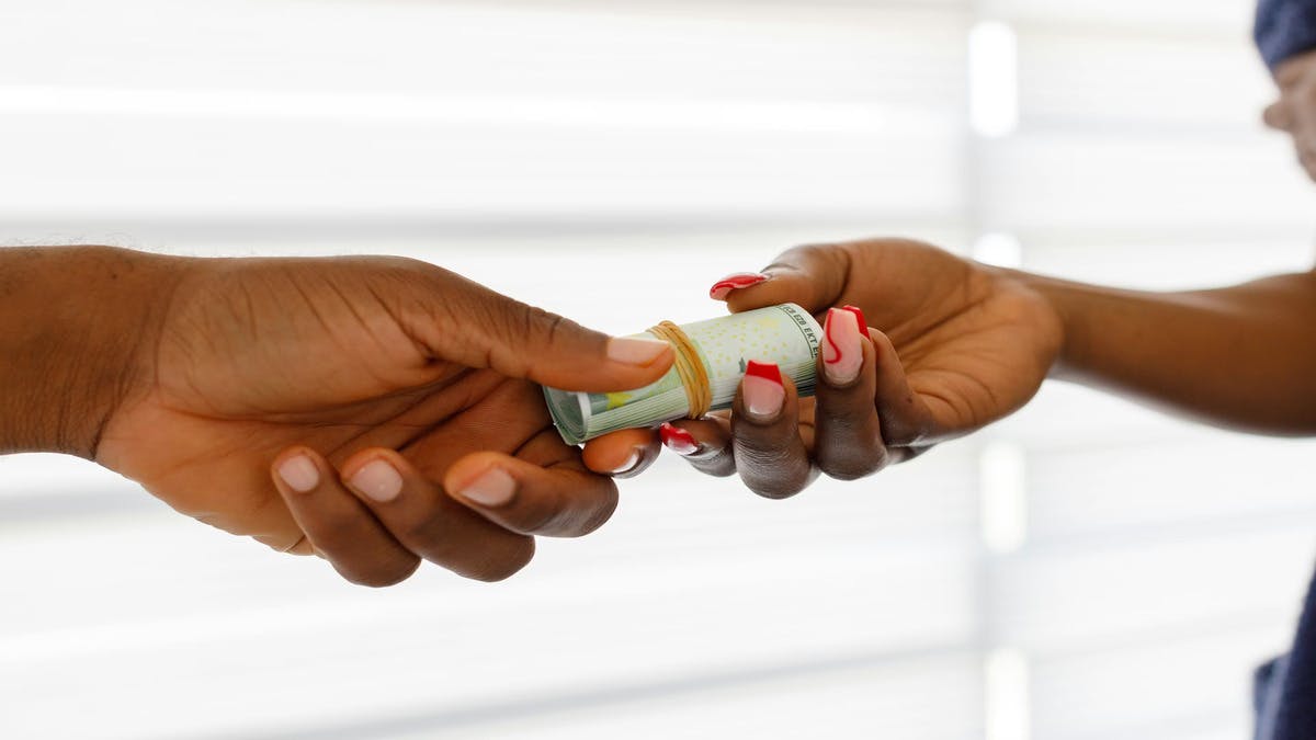 A picture of money exchanging hands