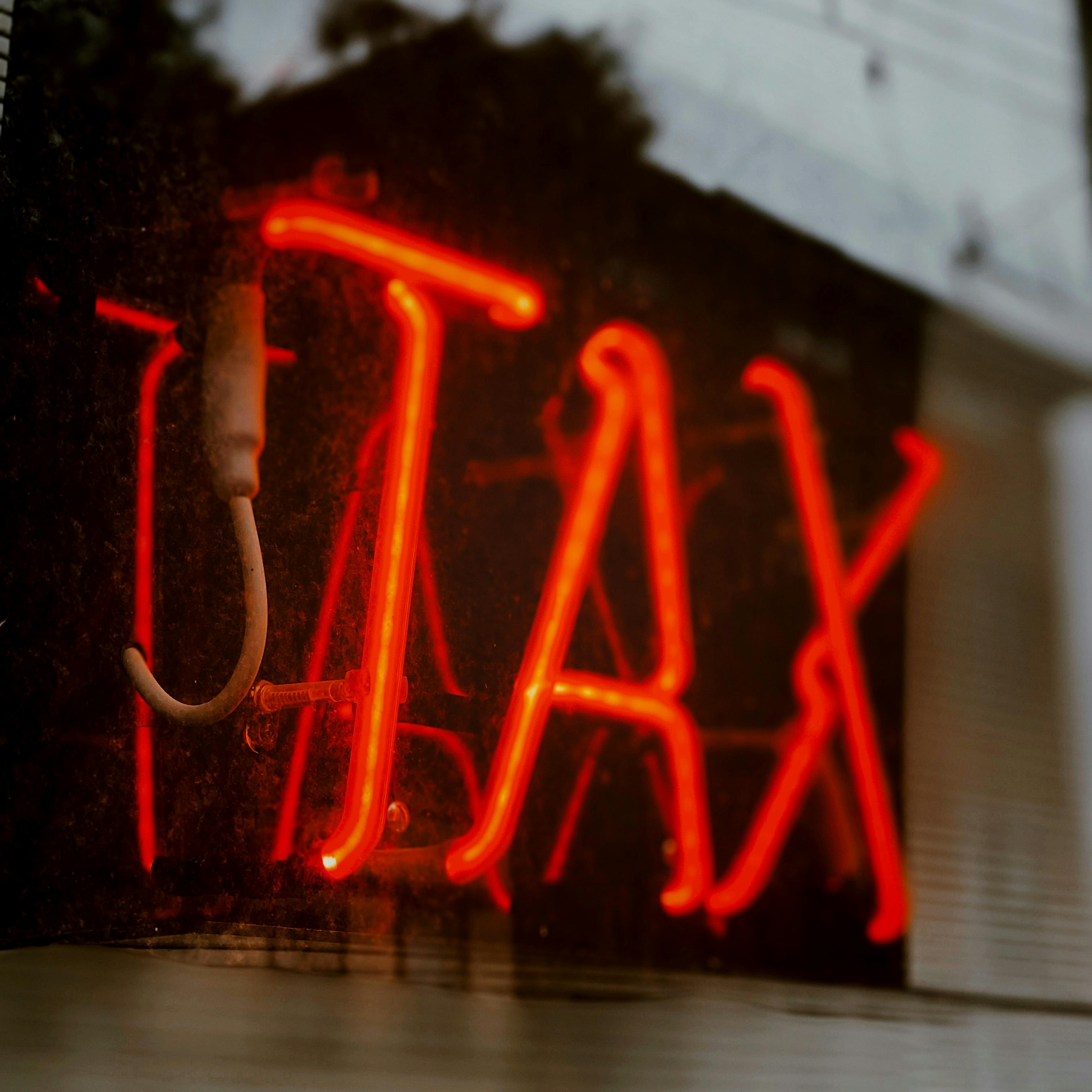 Picture of a neon sign displaying the word 'Tax'