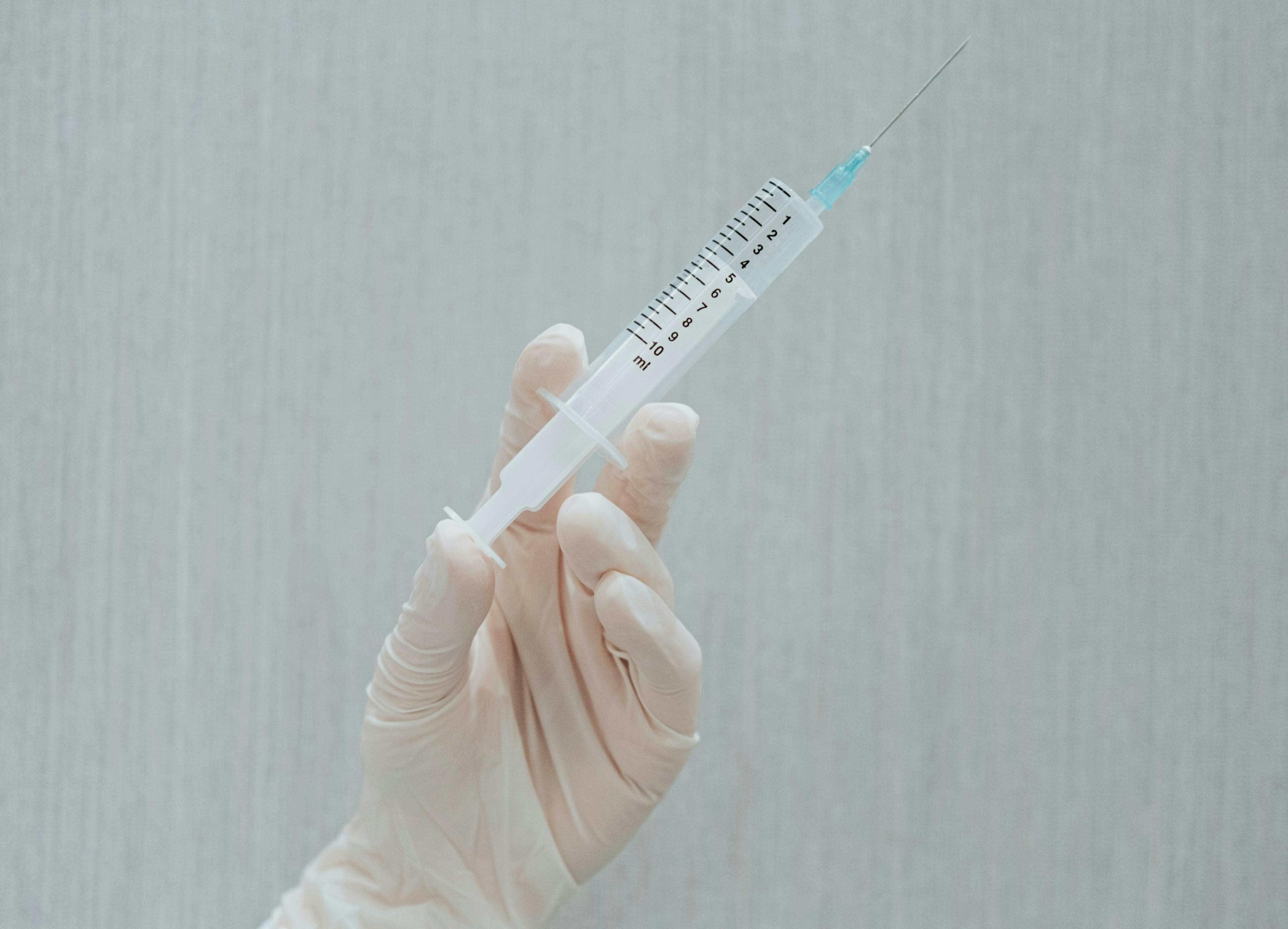 A picture of a vaccination vial being held in a doctor's hand