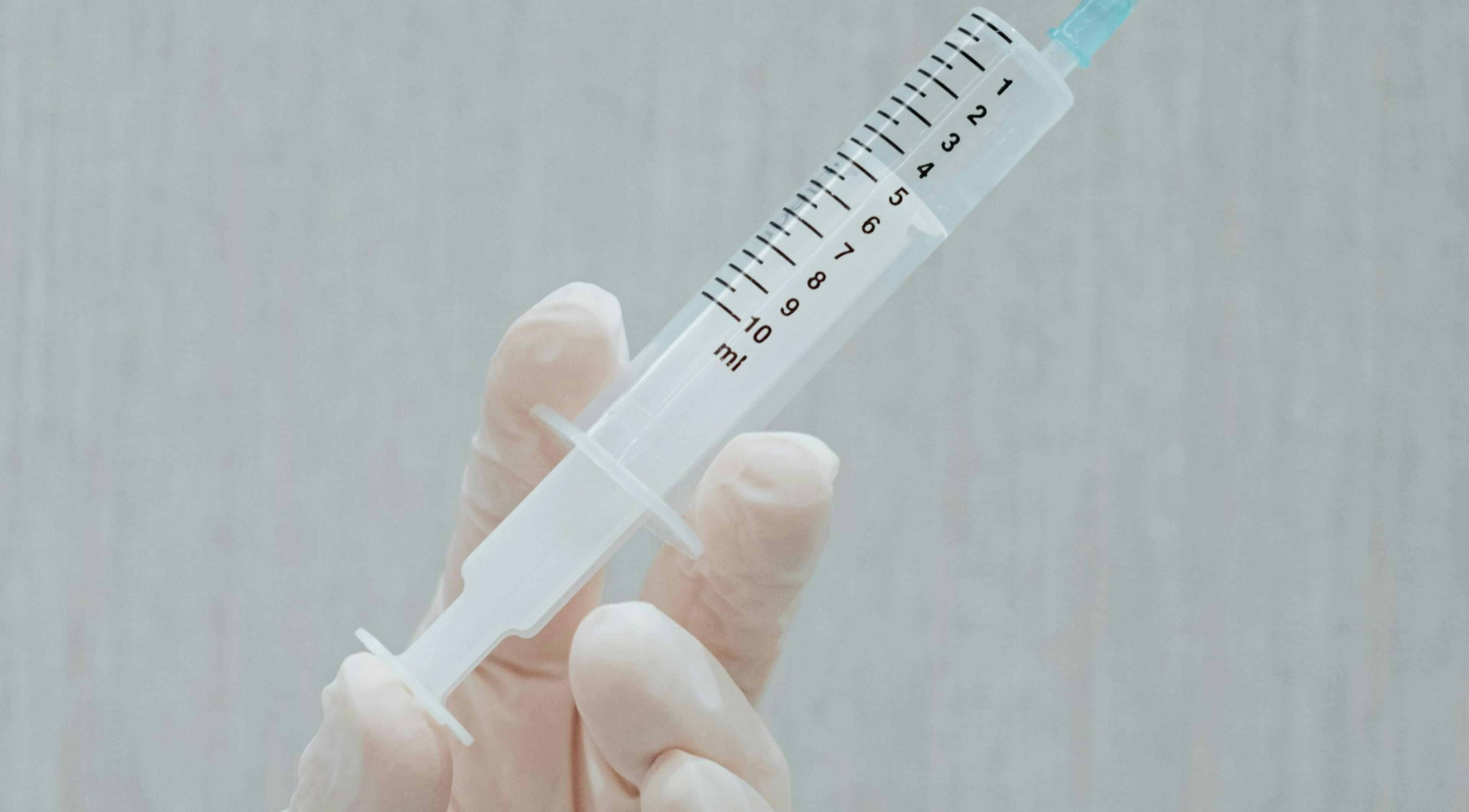 A picture of a vaccination vial being in a doctor's hand