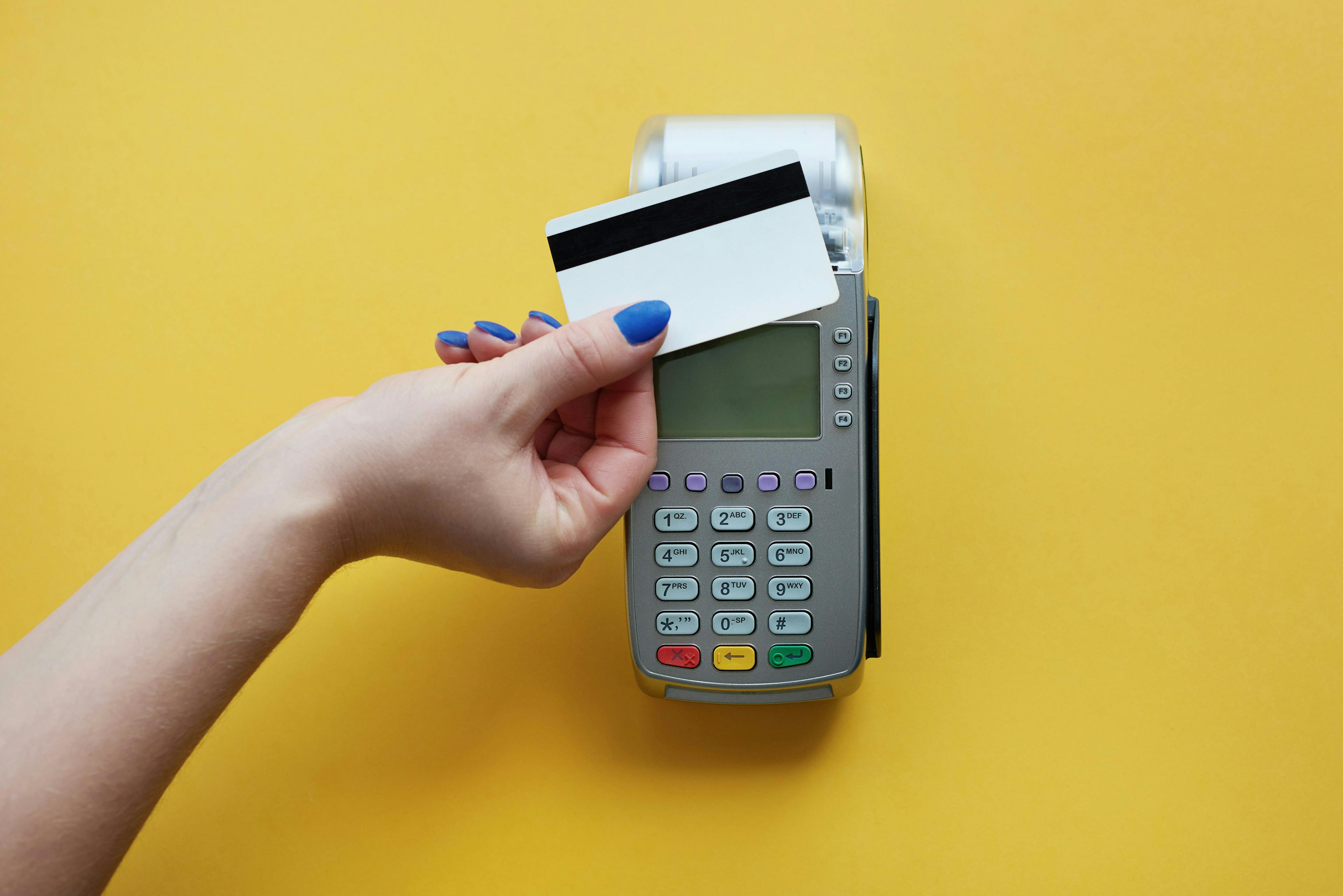 A picture of a credit card being tapped on a card reader