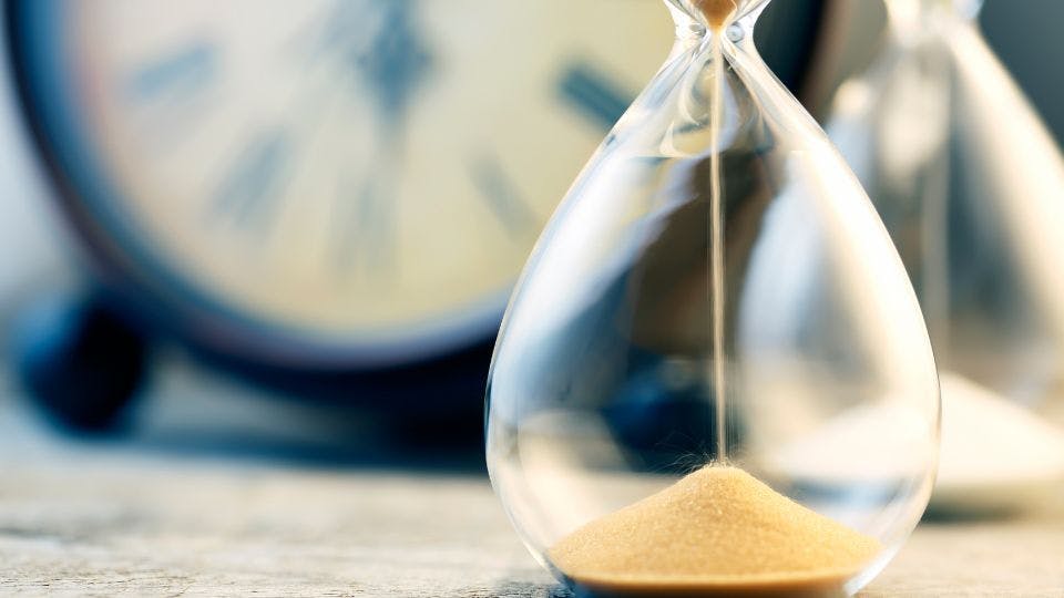 an hourglass to represent wait times for authors to reach out to academic journals