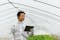 Researcher standing in a greenhouse