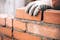 person stacking bricks as an eco-friendly construction option for civil engineering