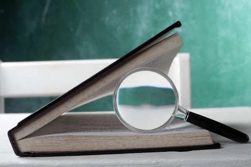 a book with a magnifying glass