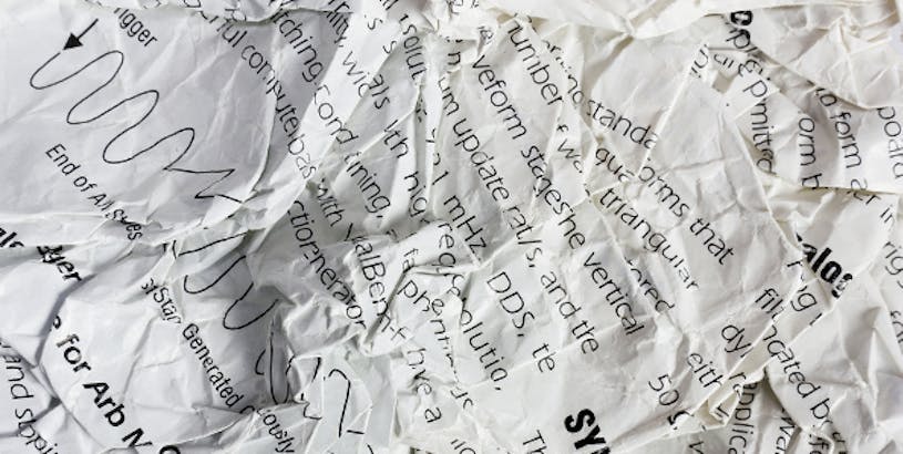crumpled research papers used for academic peer review responses