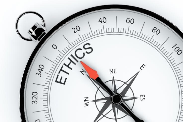 a compass pointing to the word "ethics"
