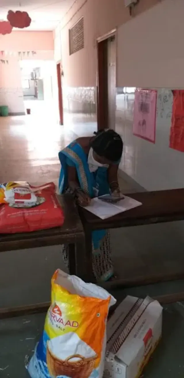 Kokila Didi keeping a record of the parents who received the kits. 