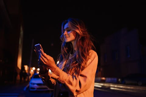 girl using phone at night