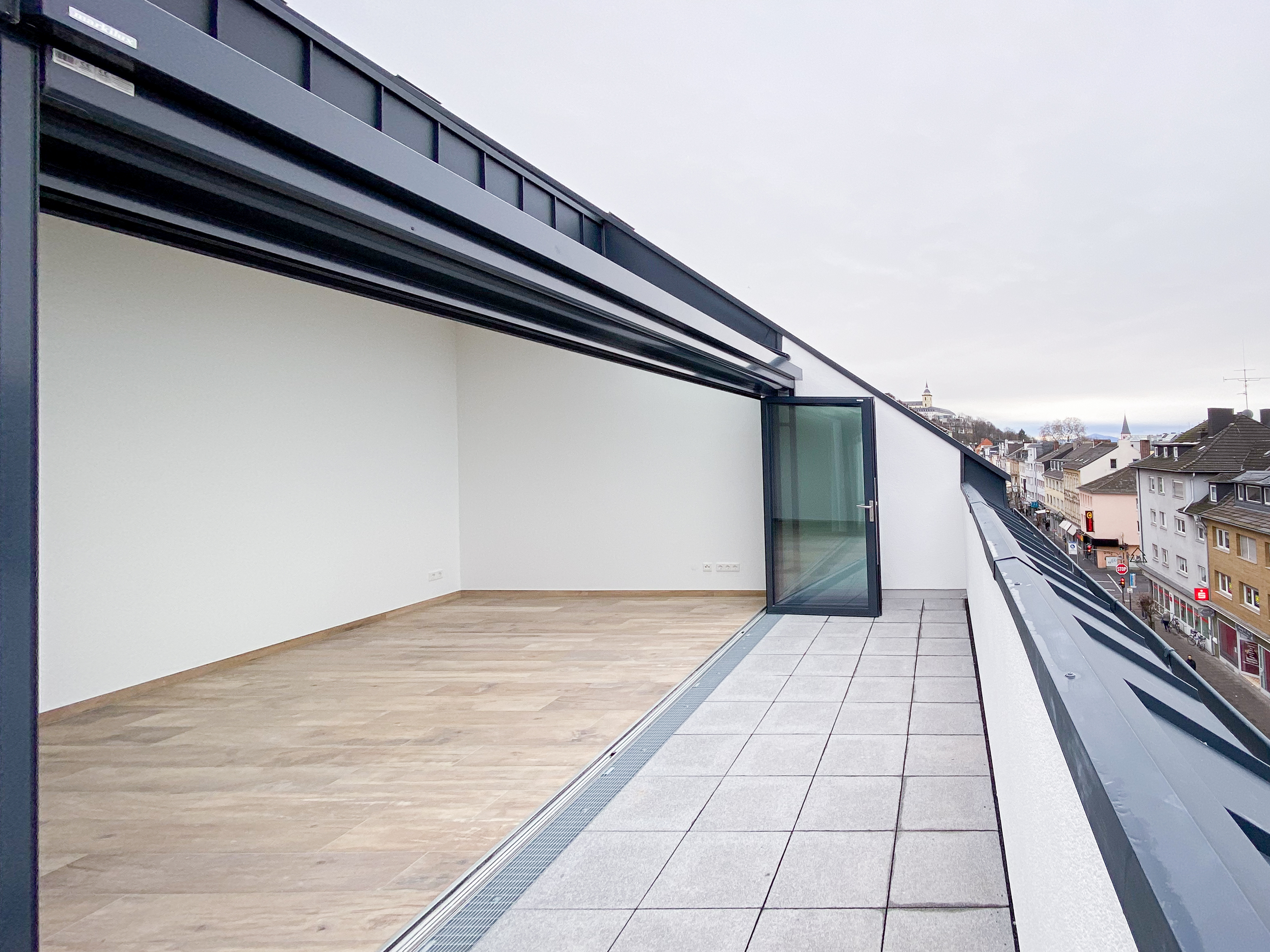Die großzügige Dachterrasse mit geöffneter Verglasung - Neubau eines Mehrfamilienhauses in der Kaiserstraße in Siegburg.