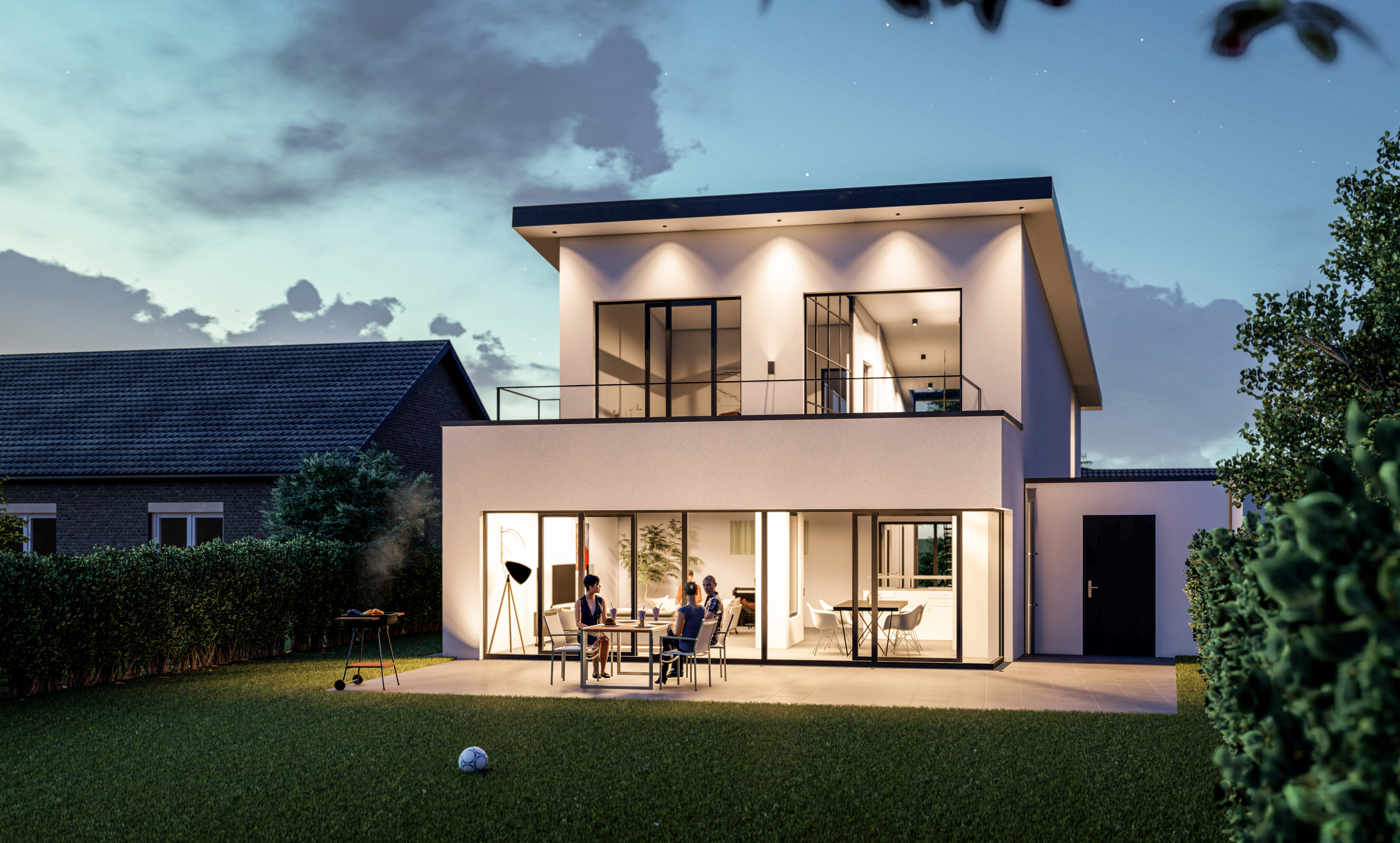 Die beleuchtete rückseitige Fassade zum Garten bei Dämmerung - Neubau eines Einfamilienhauses in Moers.