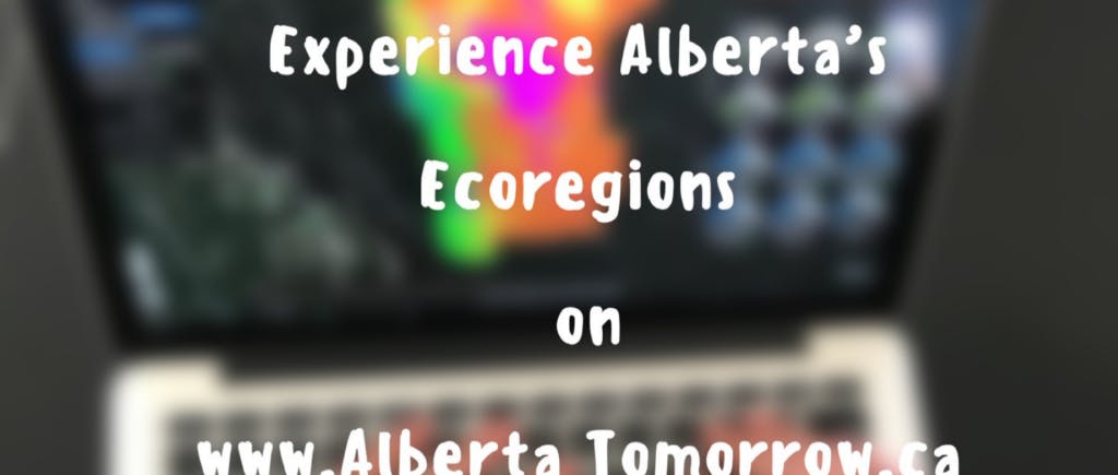 Text overlay that says Experience Alberta's Ecoregions on AlbertaTomorrow.ca on top of a blurred image of a laptop
