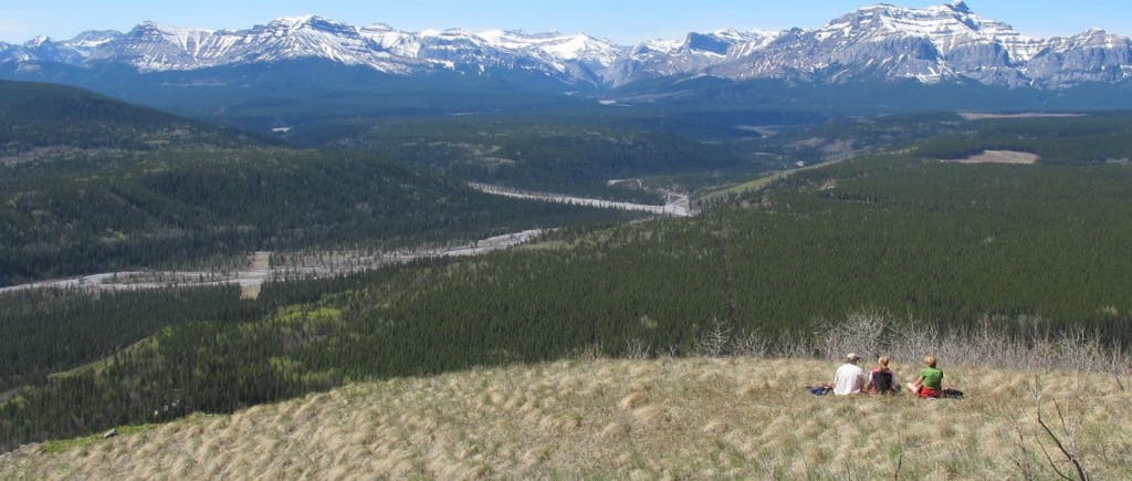 People on a hillside overlooking Ghost River