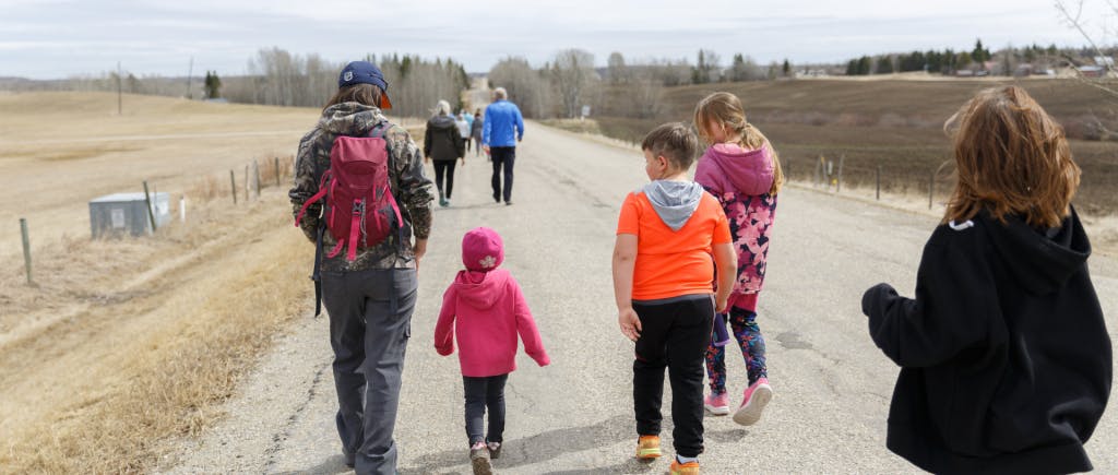 Group of young student walking along a roadside