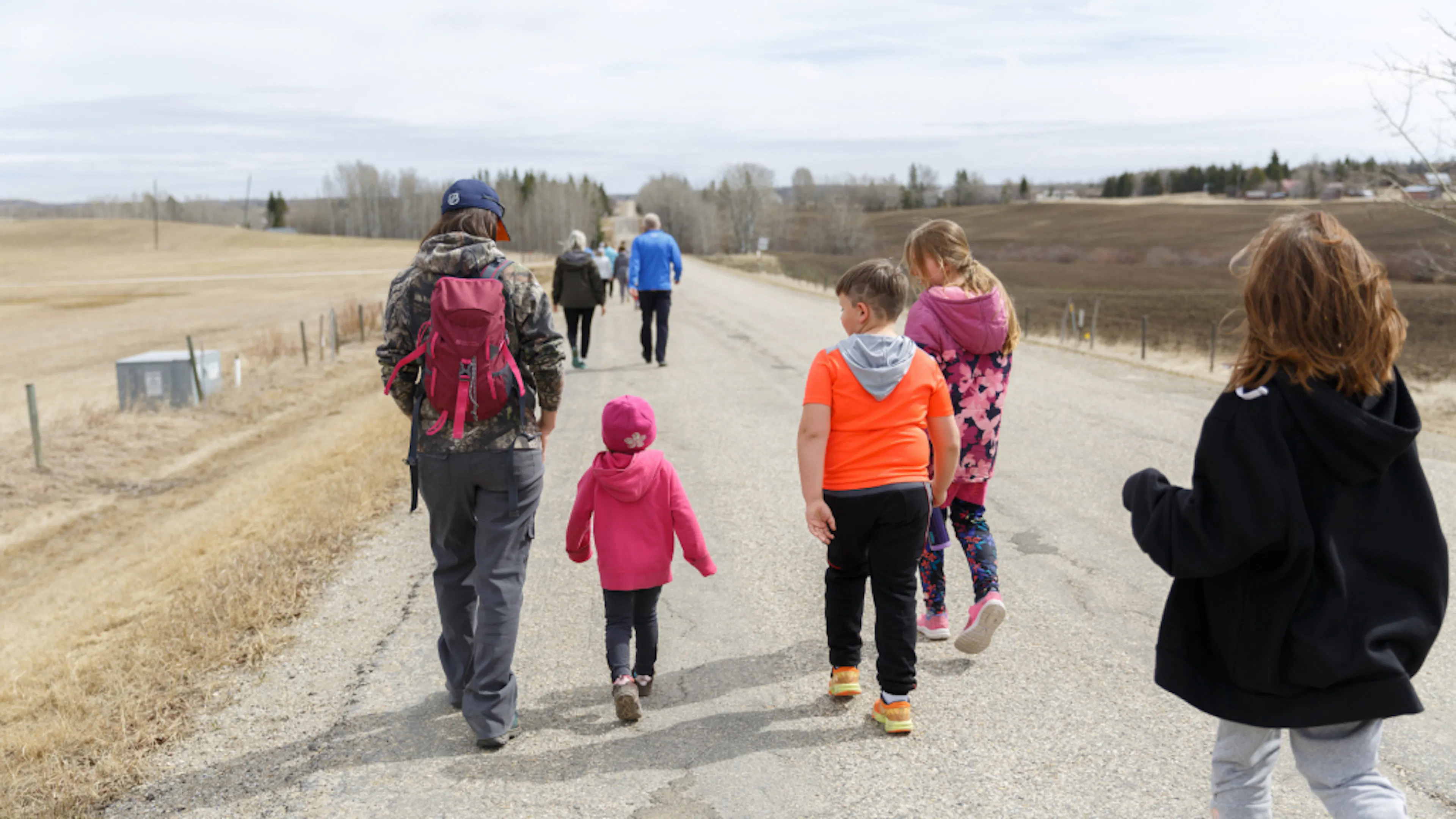 Group of young student walking along a roadside