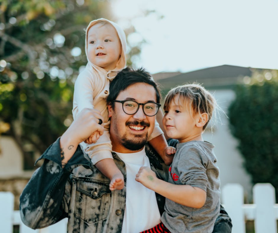 Father holding his two children
