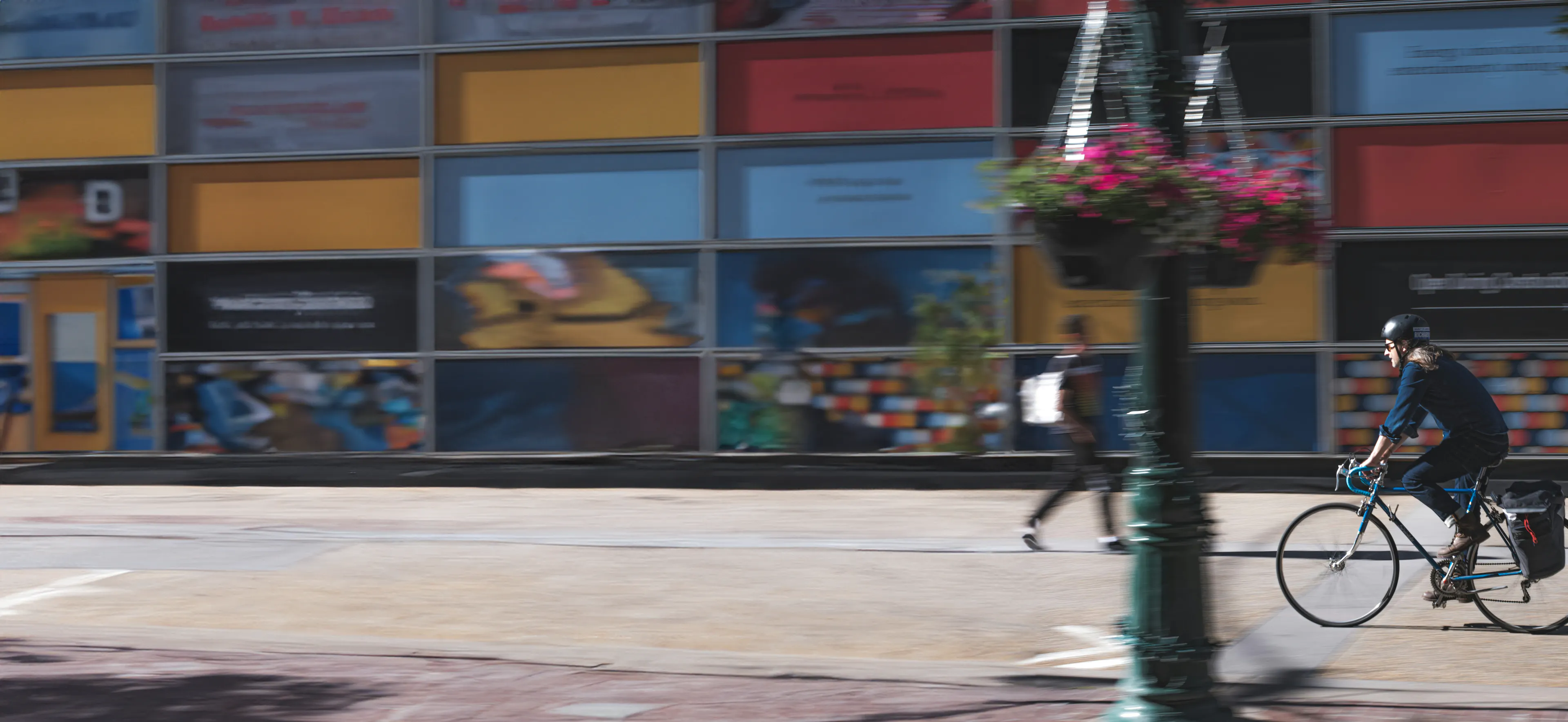Person biking on a city sidewalk