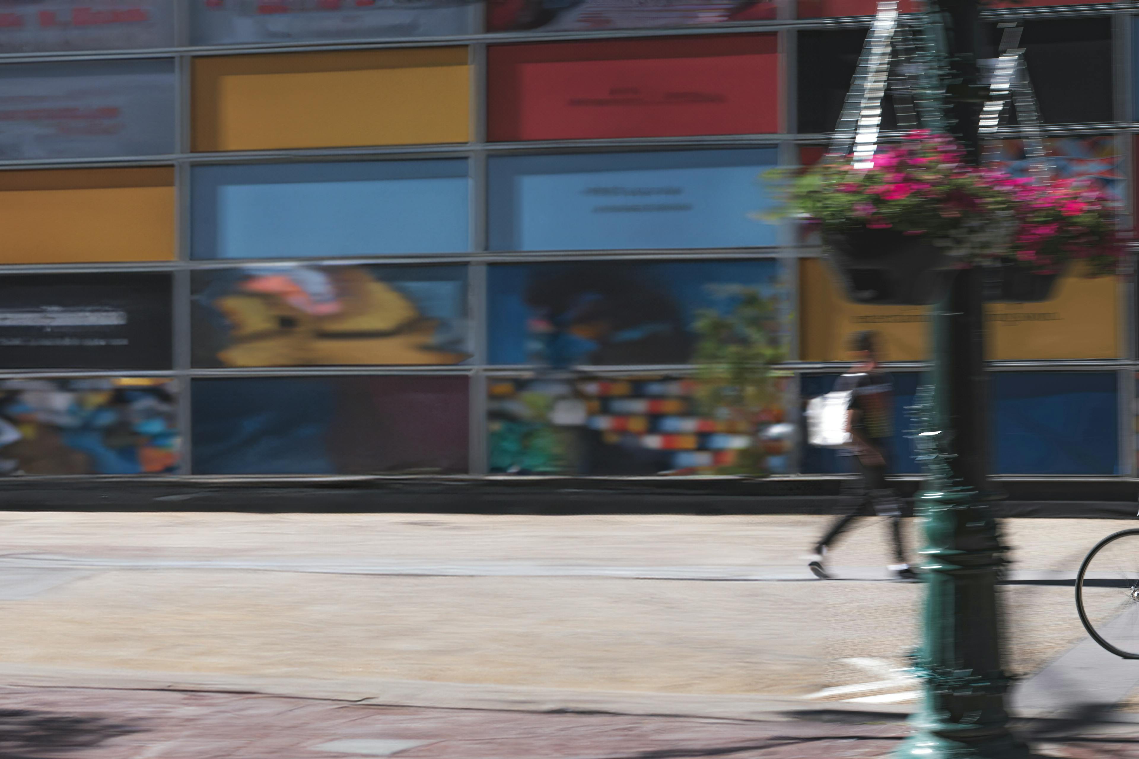 Person biking on a city sidewalk
