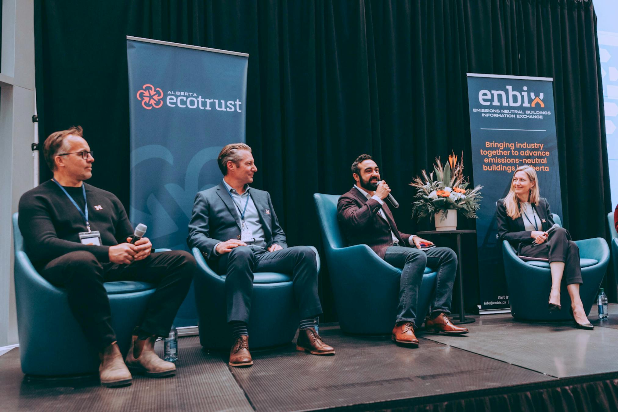 Five panelists sit on stage at an ENBIX presentation