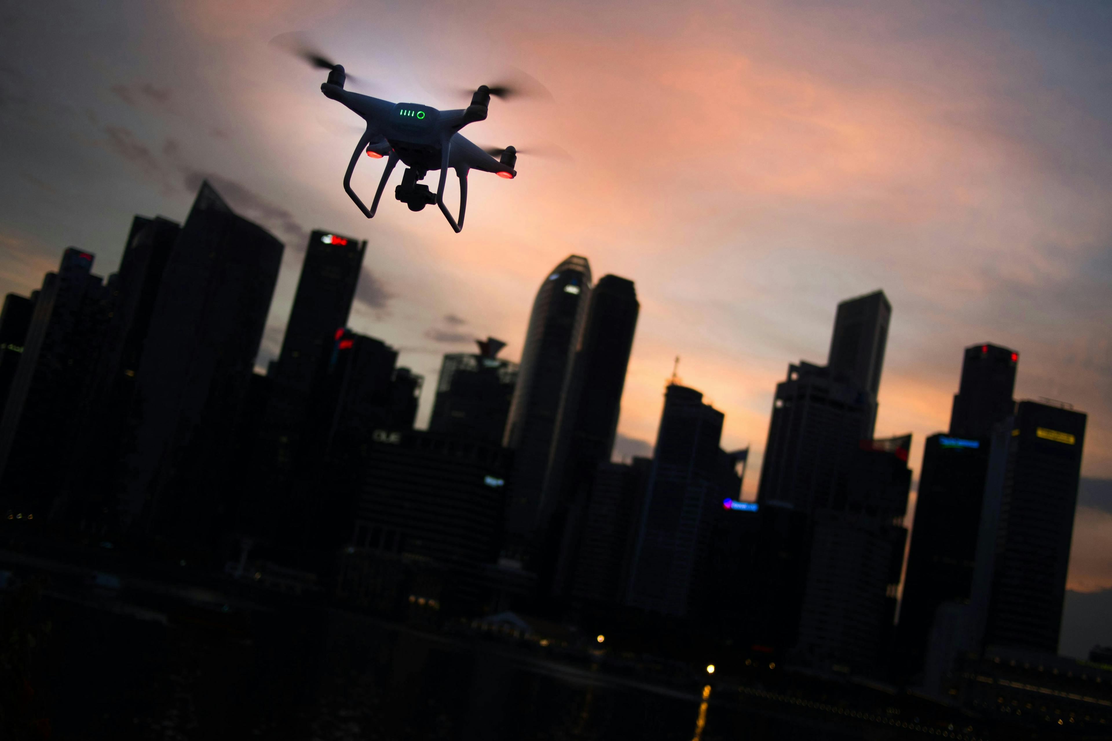 drone flying in front of downtown buildings