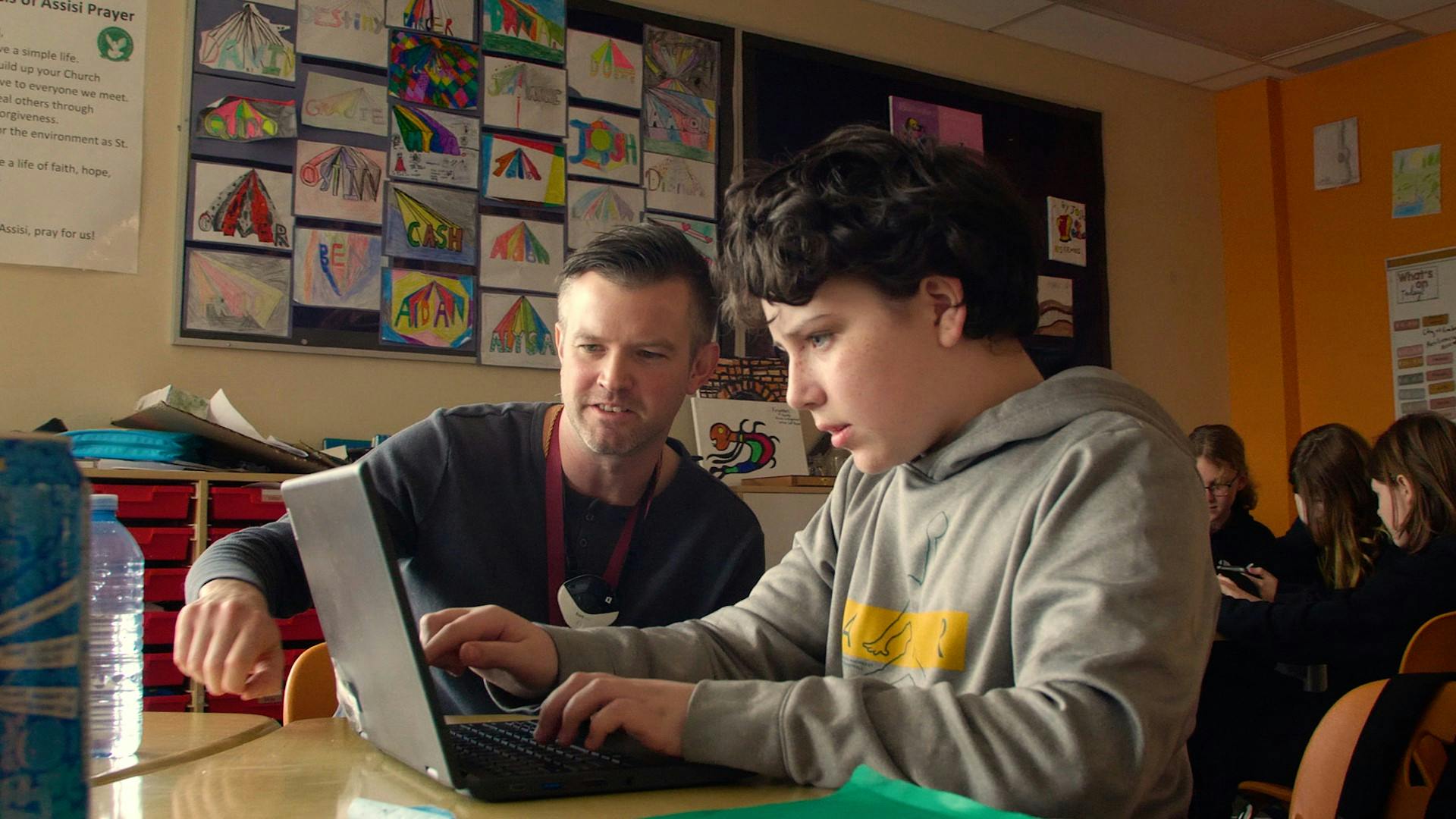 ALCDSB FSL Elementary teacher sitting with a student in front of a computer