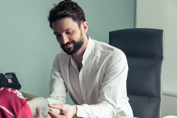 Docteur en pleine consultation avec une patiente intéressée par la chirurgie mammaire.