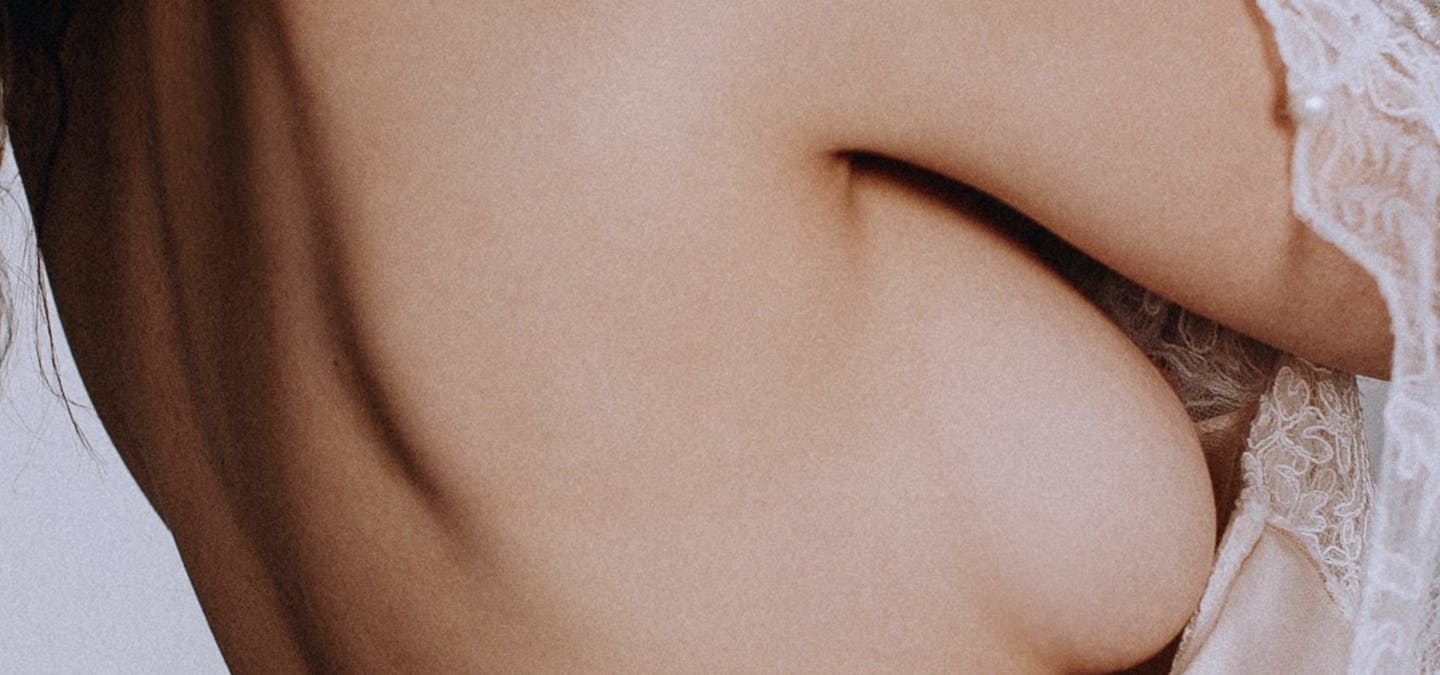 Photo d'une jeune femme avec un focus sur la poitrine.